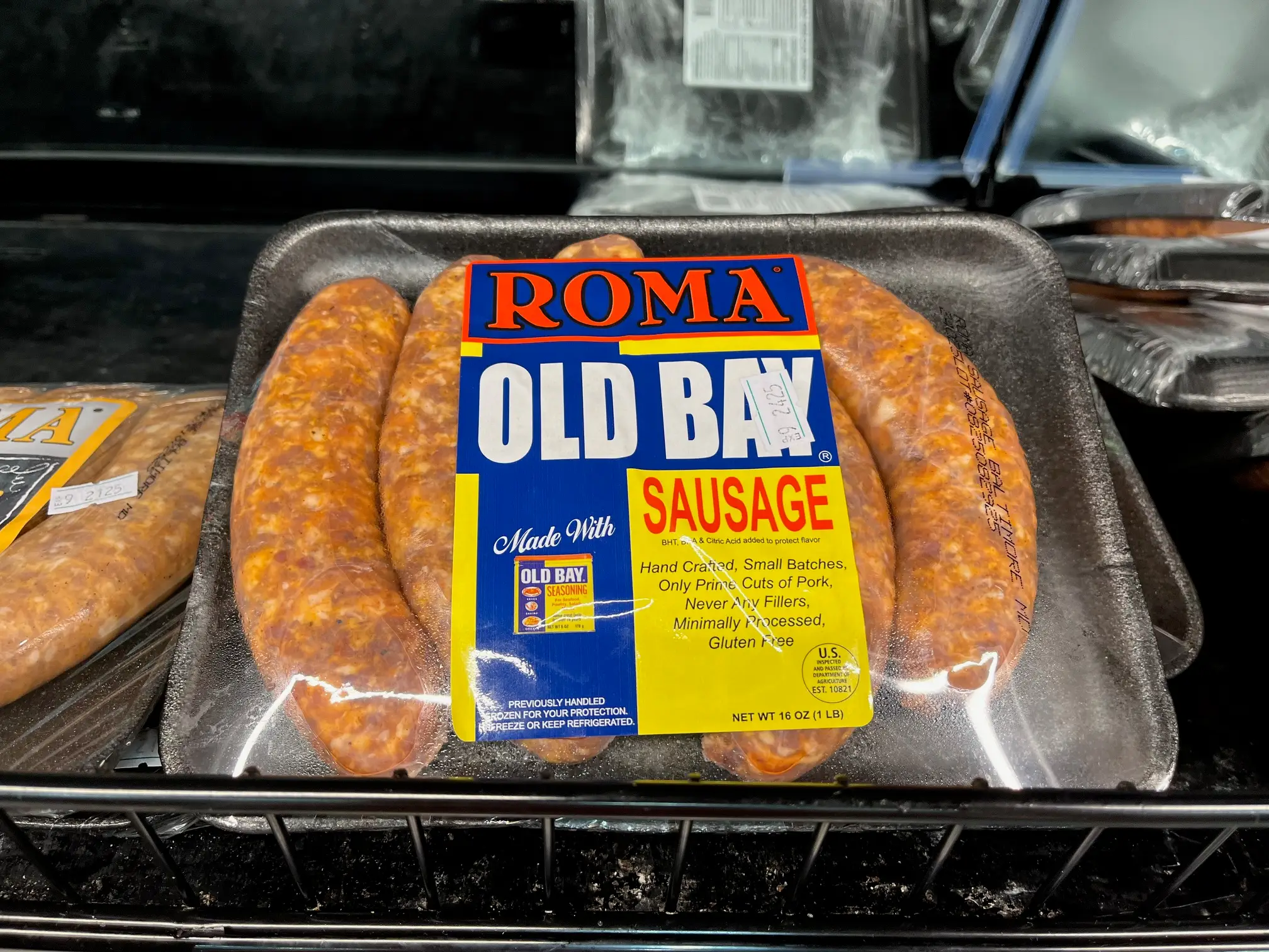A package of Roma Old Bay-flavored sausages sit in a cooler case at Grocery Outlet