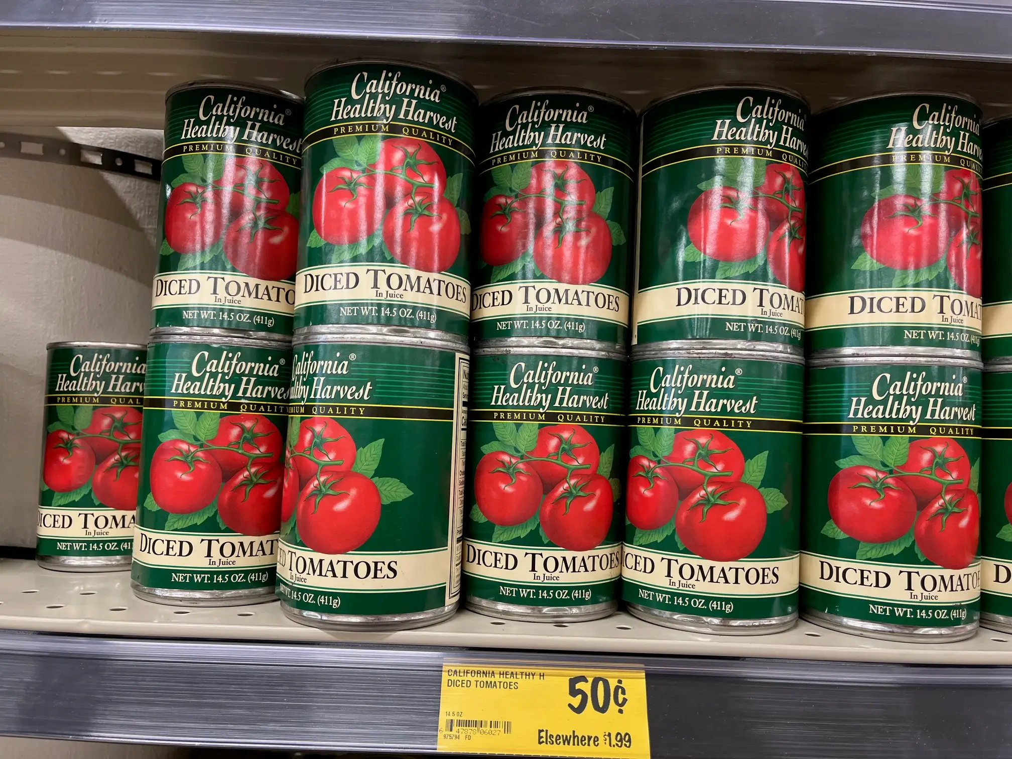 Cans of California Healthy Harvest diced tomatoes sit on a shelf at Grocery Outlet.