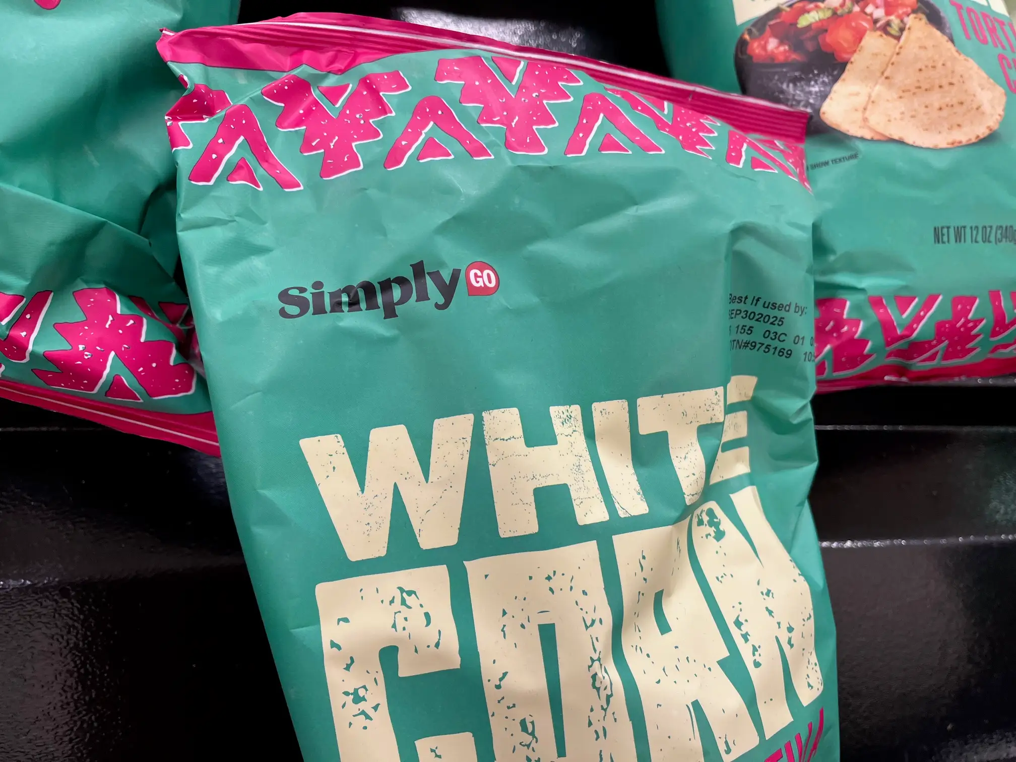 A bag of White Corn Tortilla chips carries the SimplyGo name.
