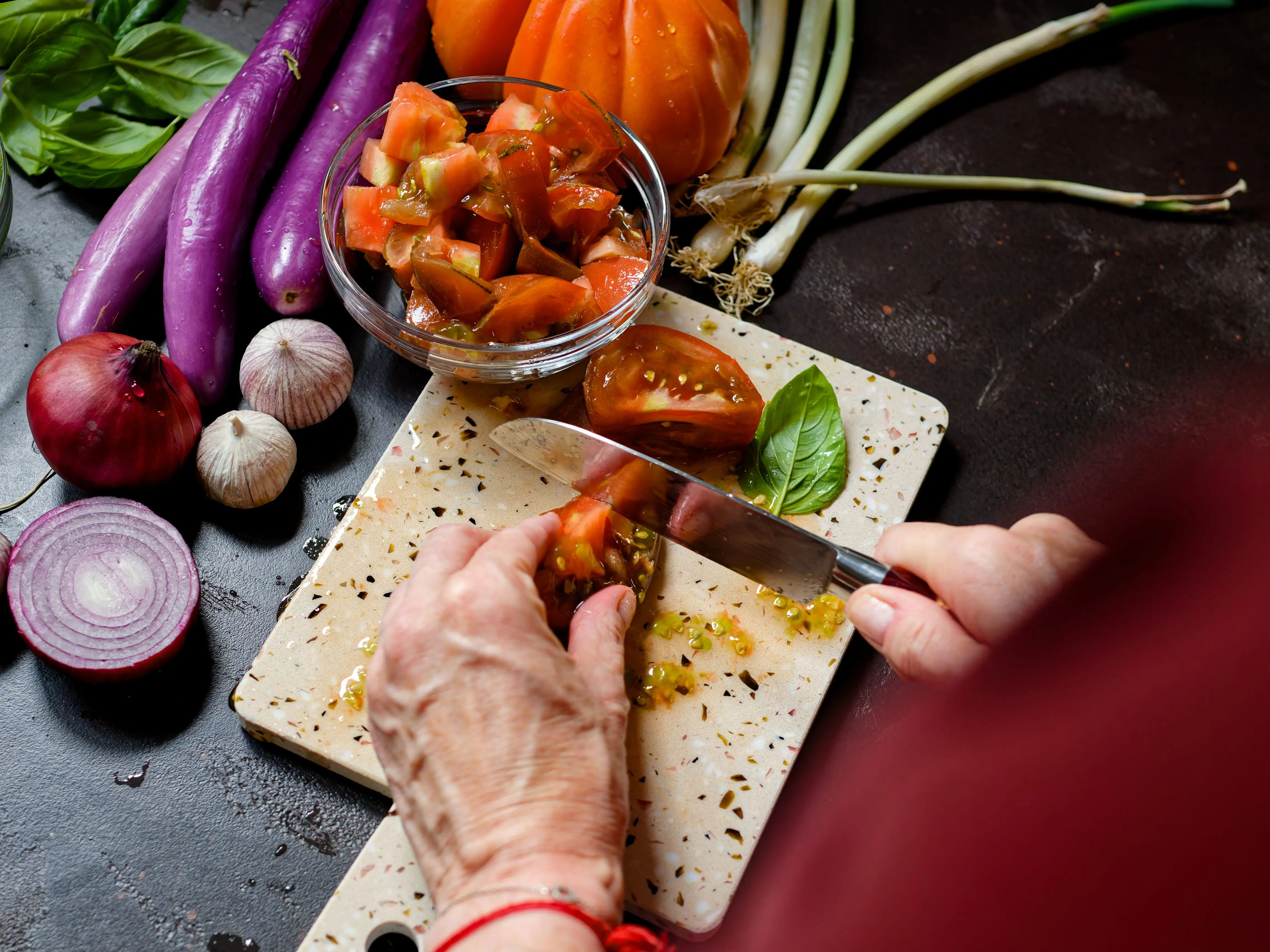 a person chopping a tomato