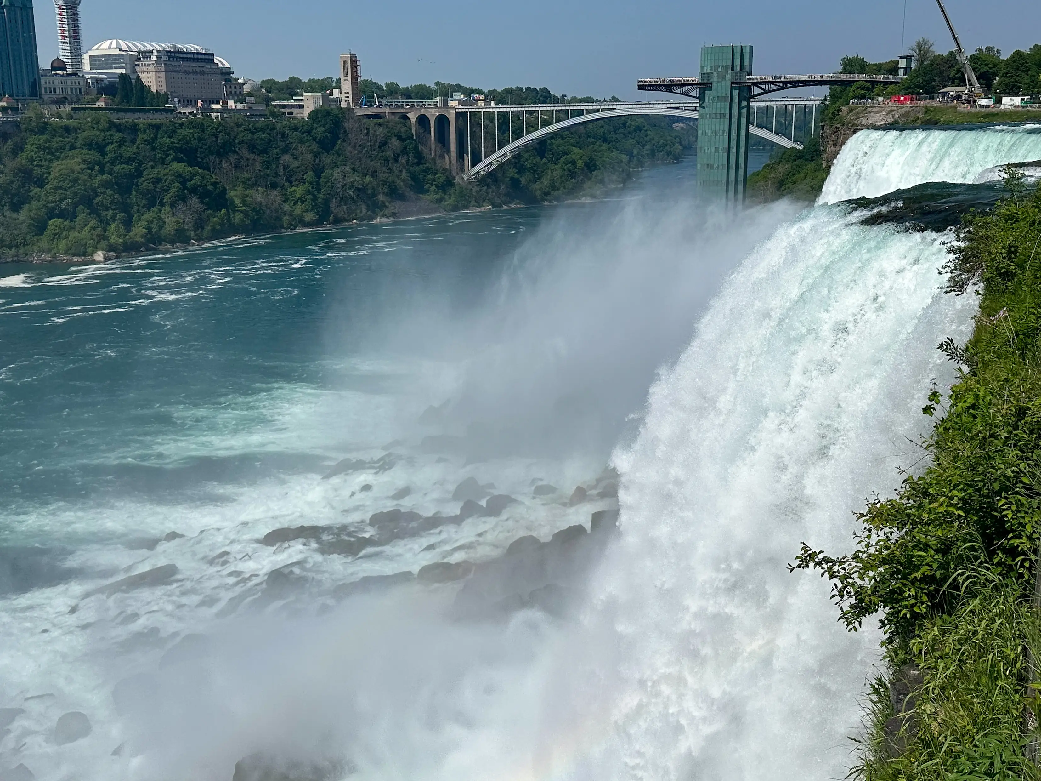 A view of Niagara Falls with a city in the background.