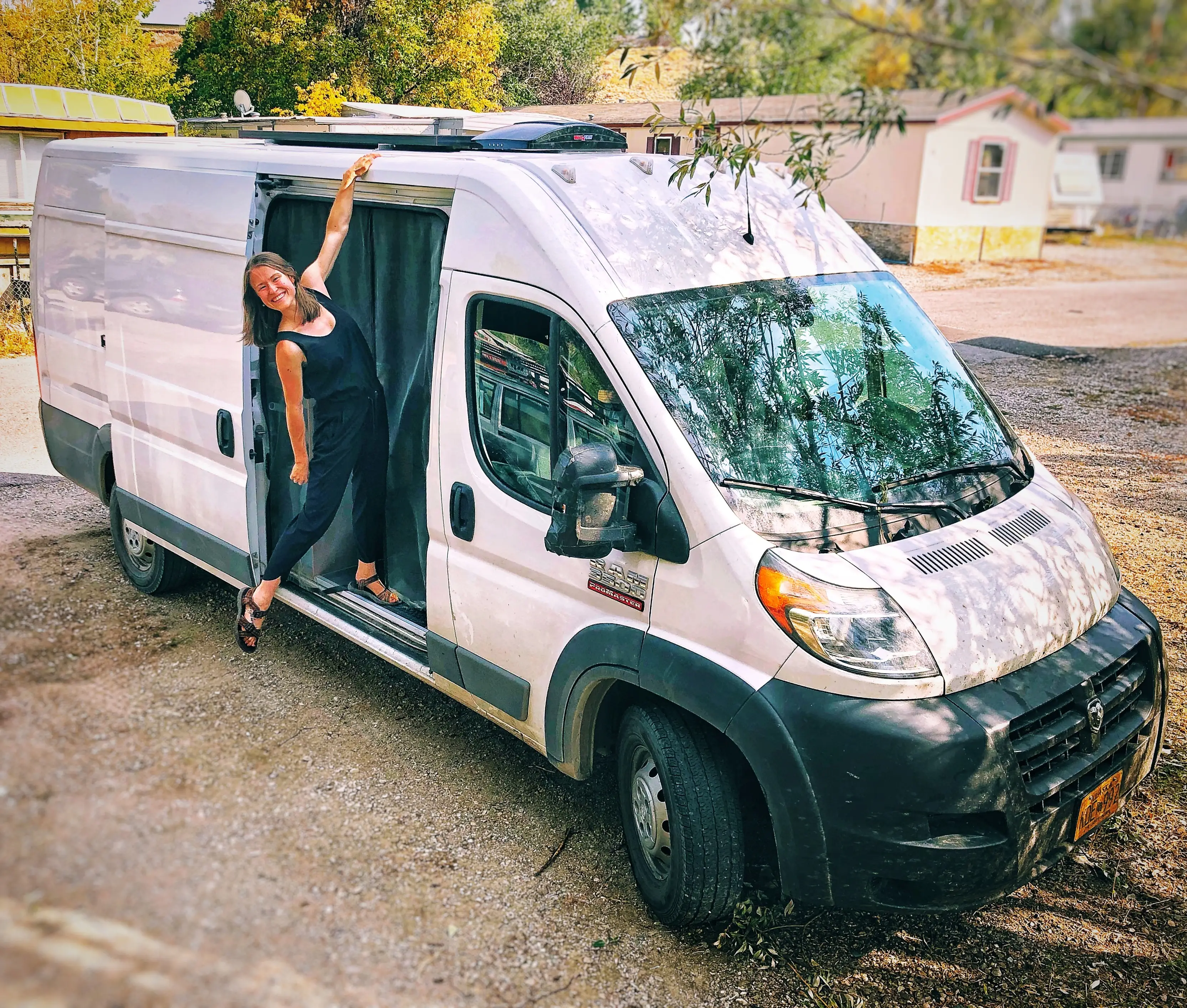 Author Amber McDaniel posing standing outside of a van