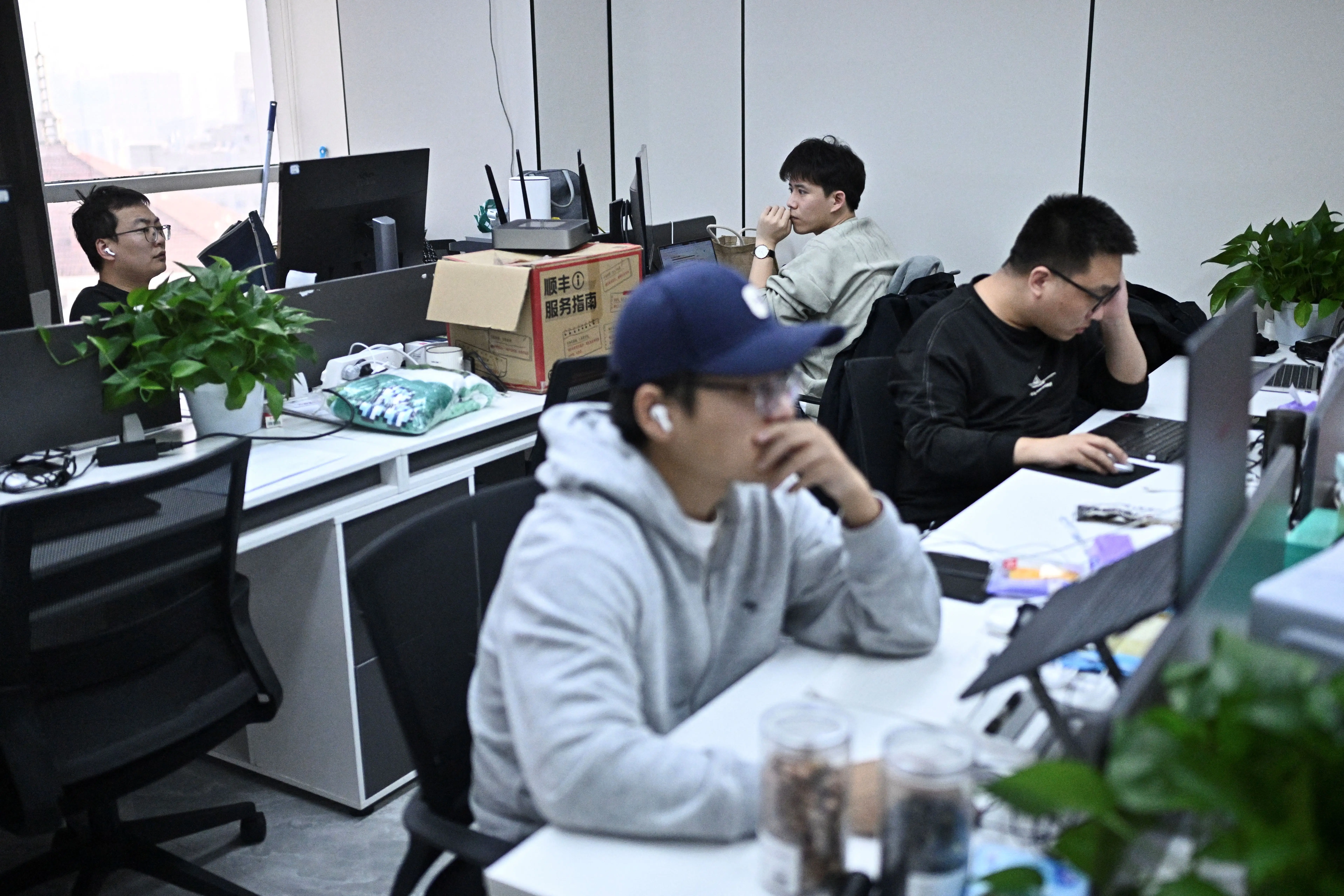 Workers at the AIpai video generation platform at their office in Beijing on October 15, 2025