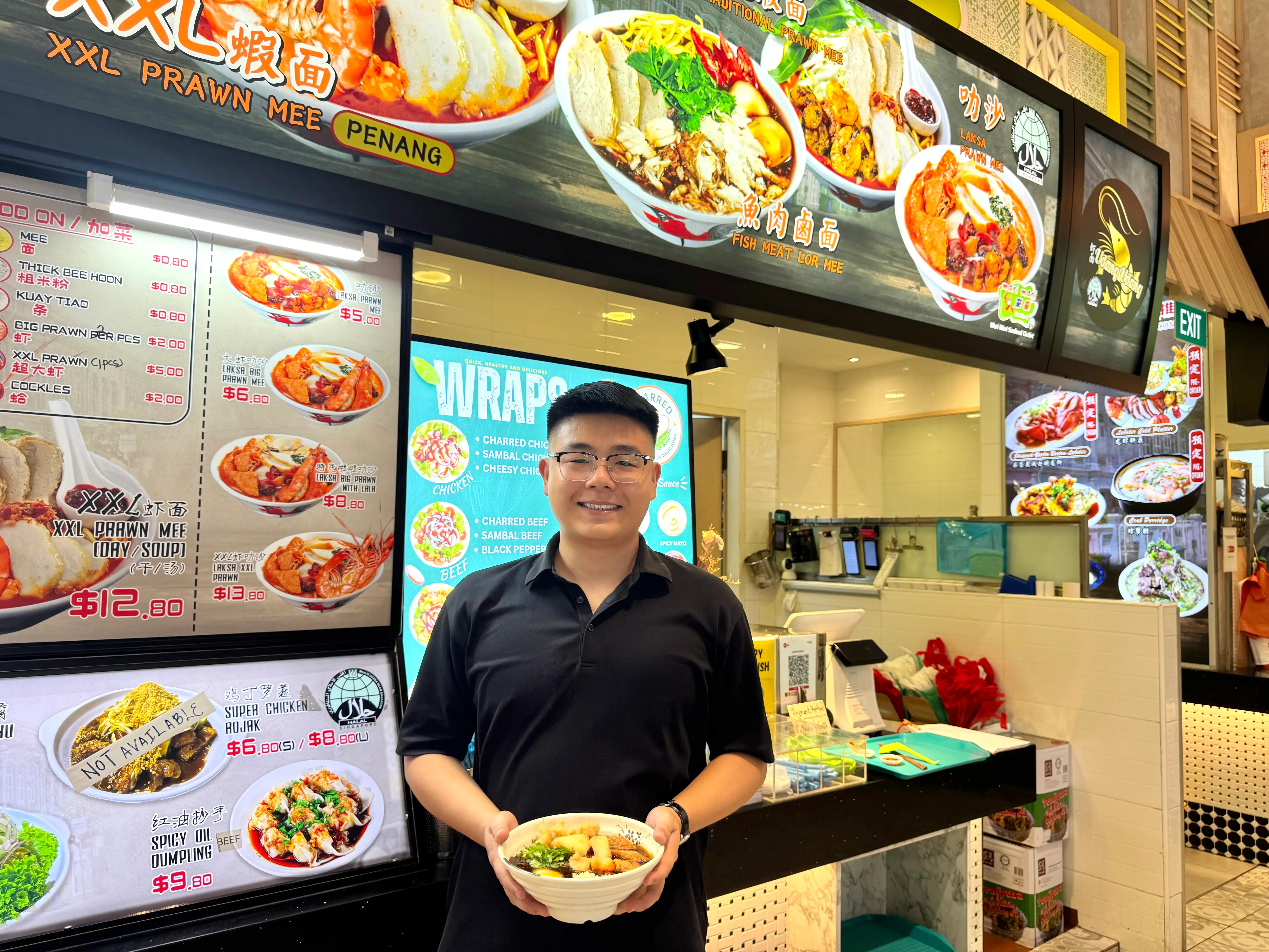 Ethan Tan standing in front of his hawker stall.