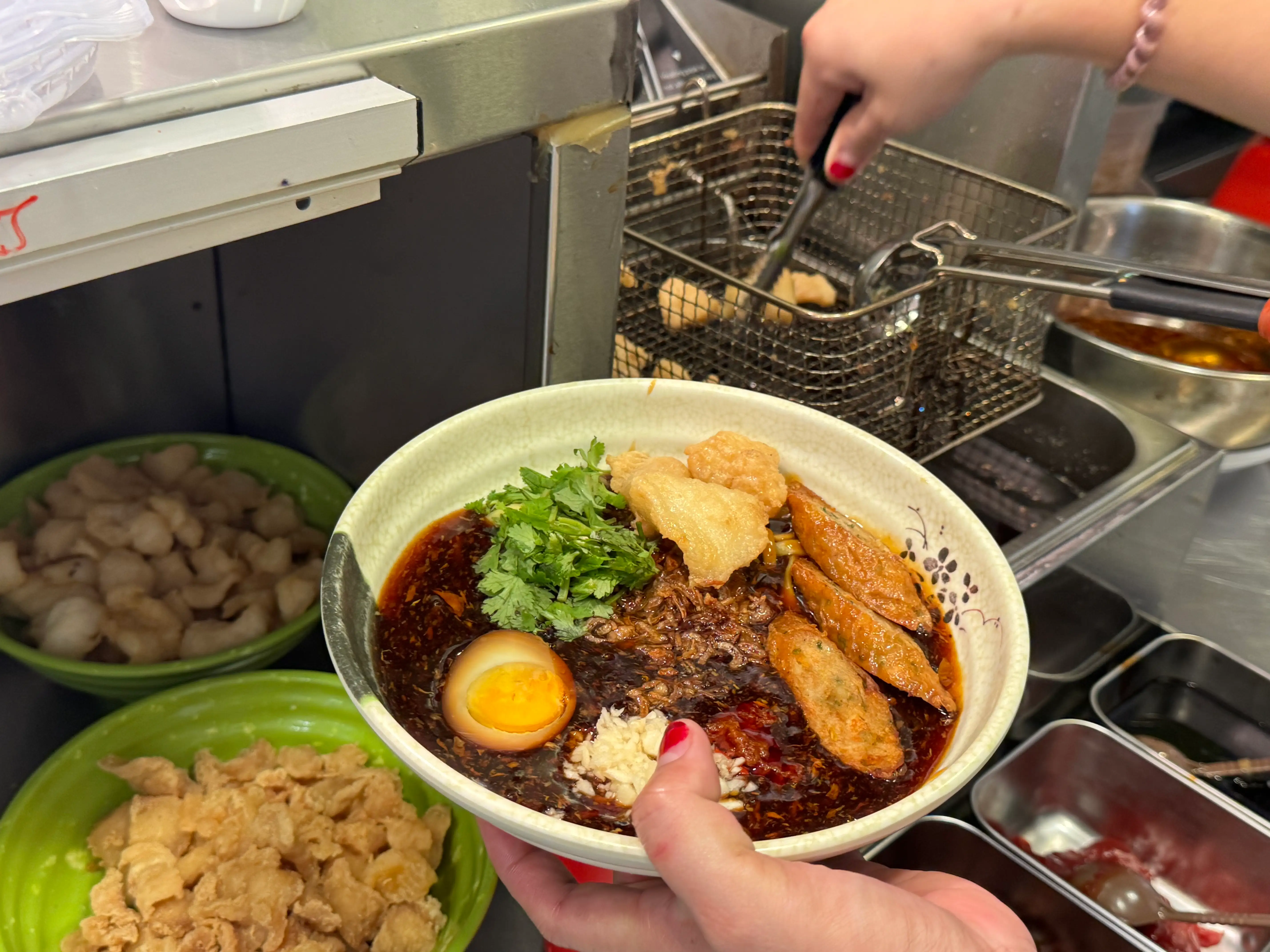 Tan's staff plating up a bowl of Lor Mee.