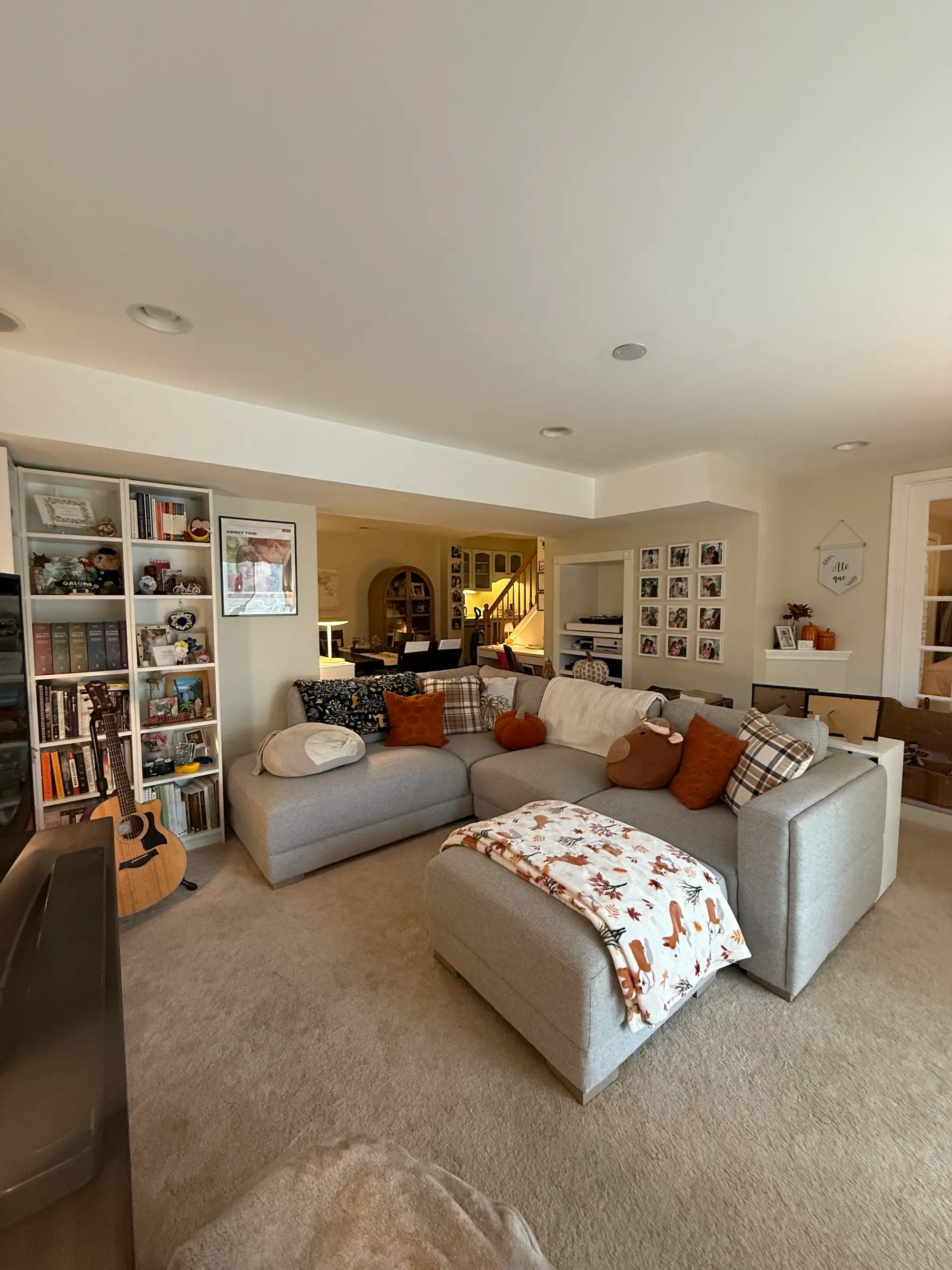 A sitting area with a large couch and bookshelves.