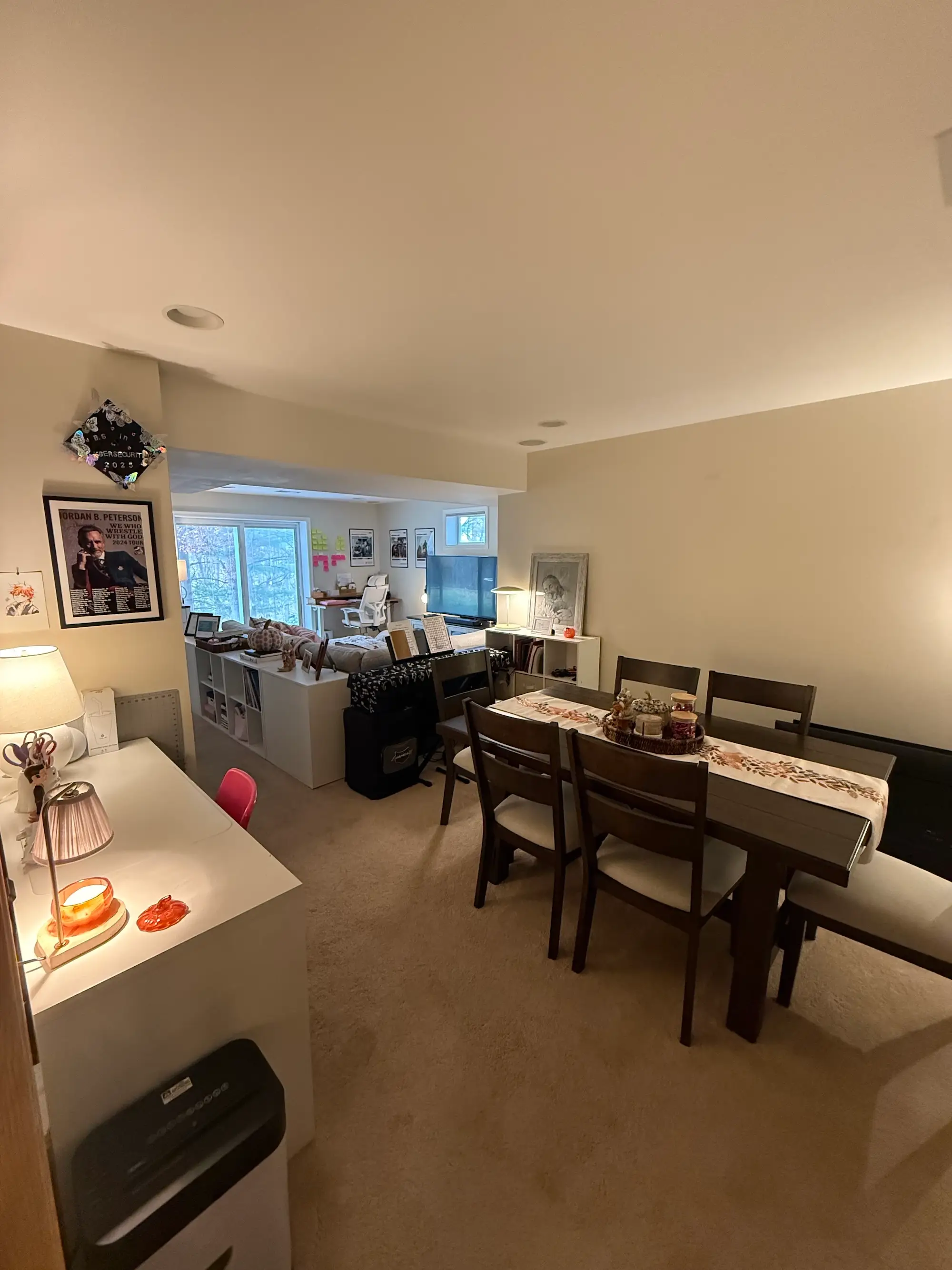 A dining area that leads into a living room.