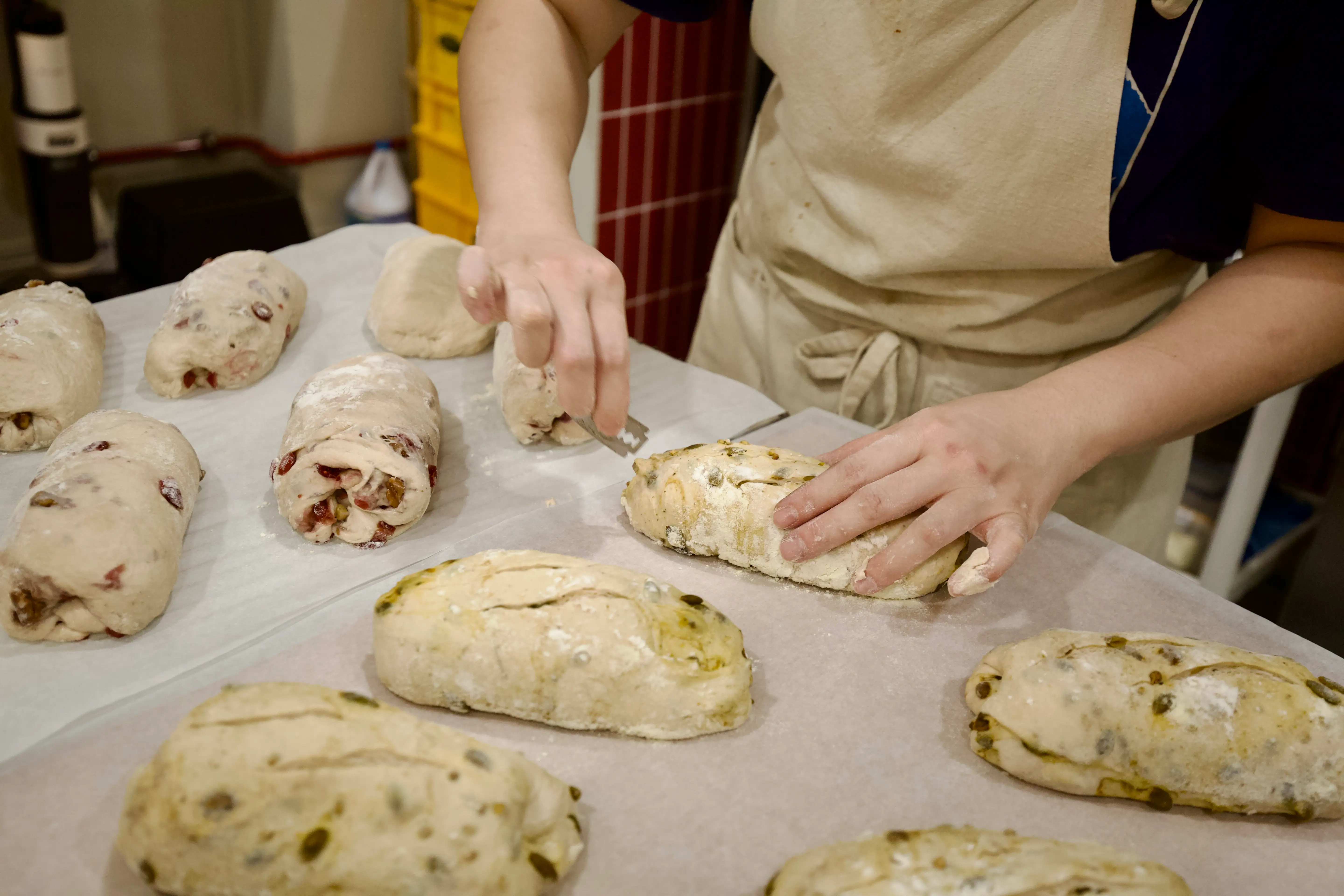 Au prepping sourdough loaves for the oven.
