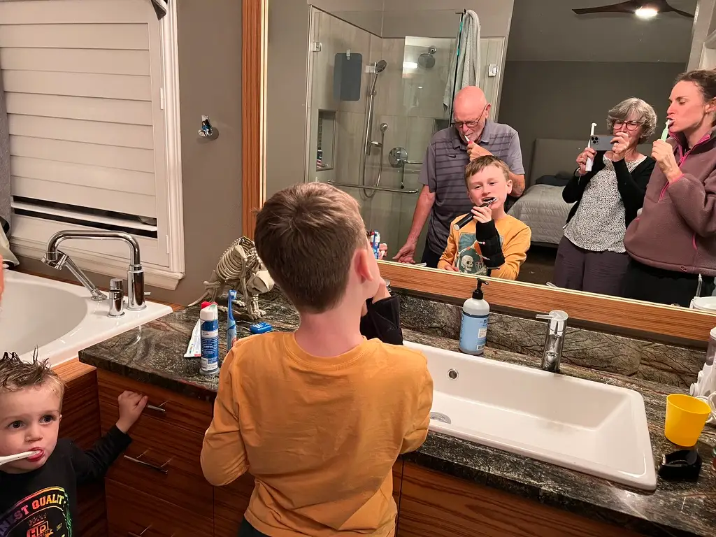 Family brushing teeth together