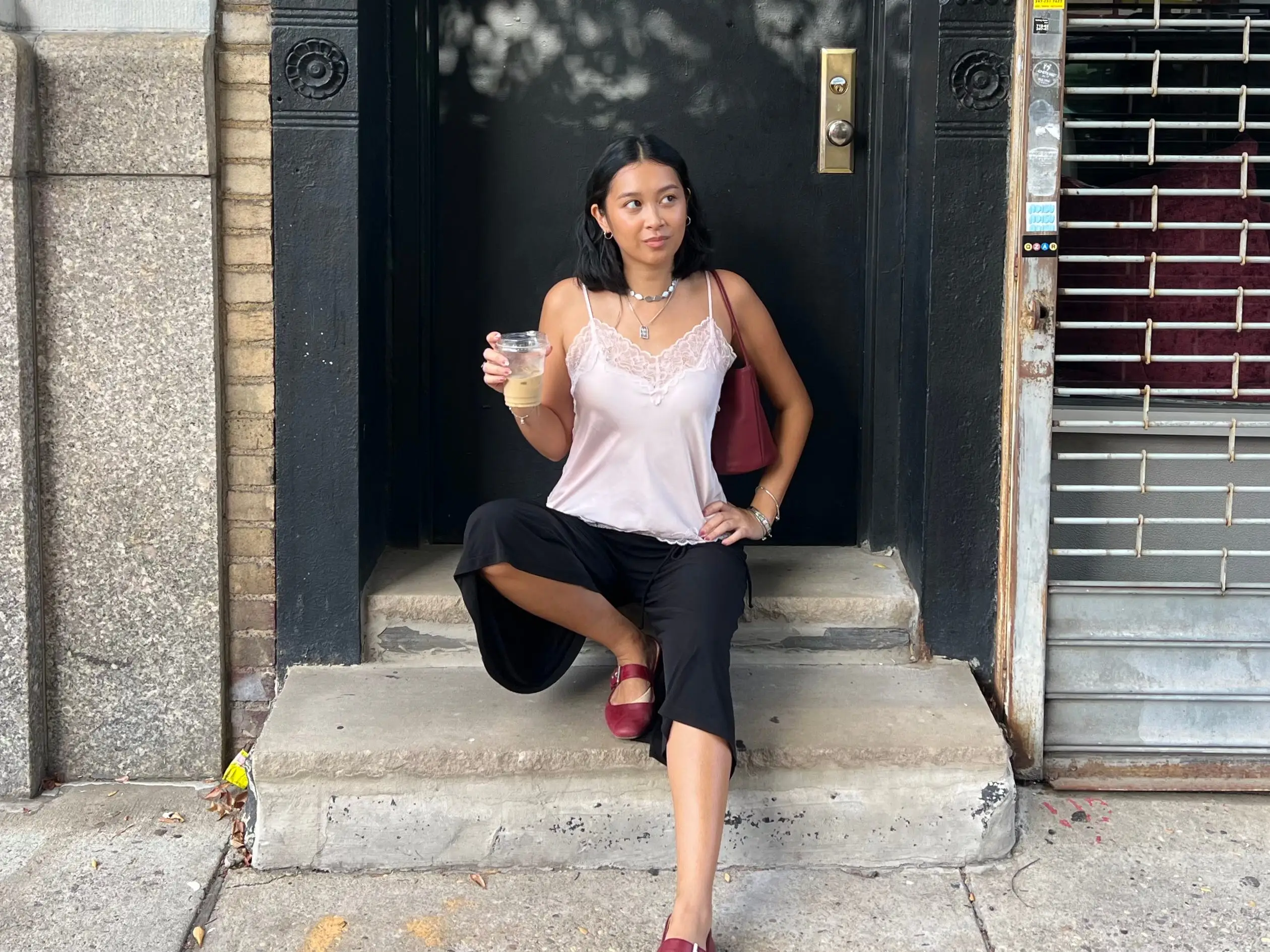 The author posing on a step on a sidewalk in New York City.