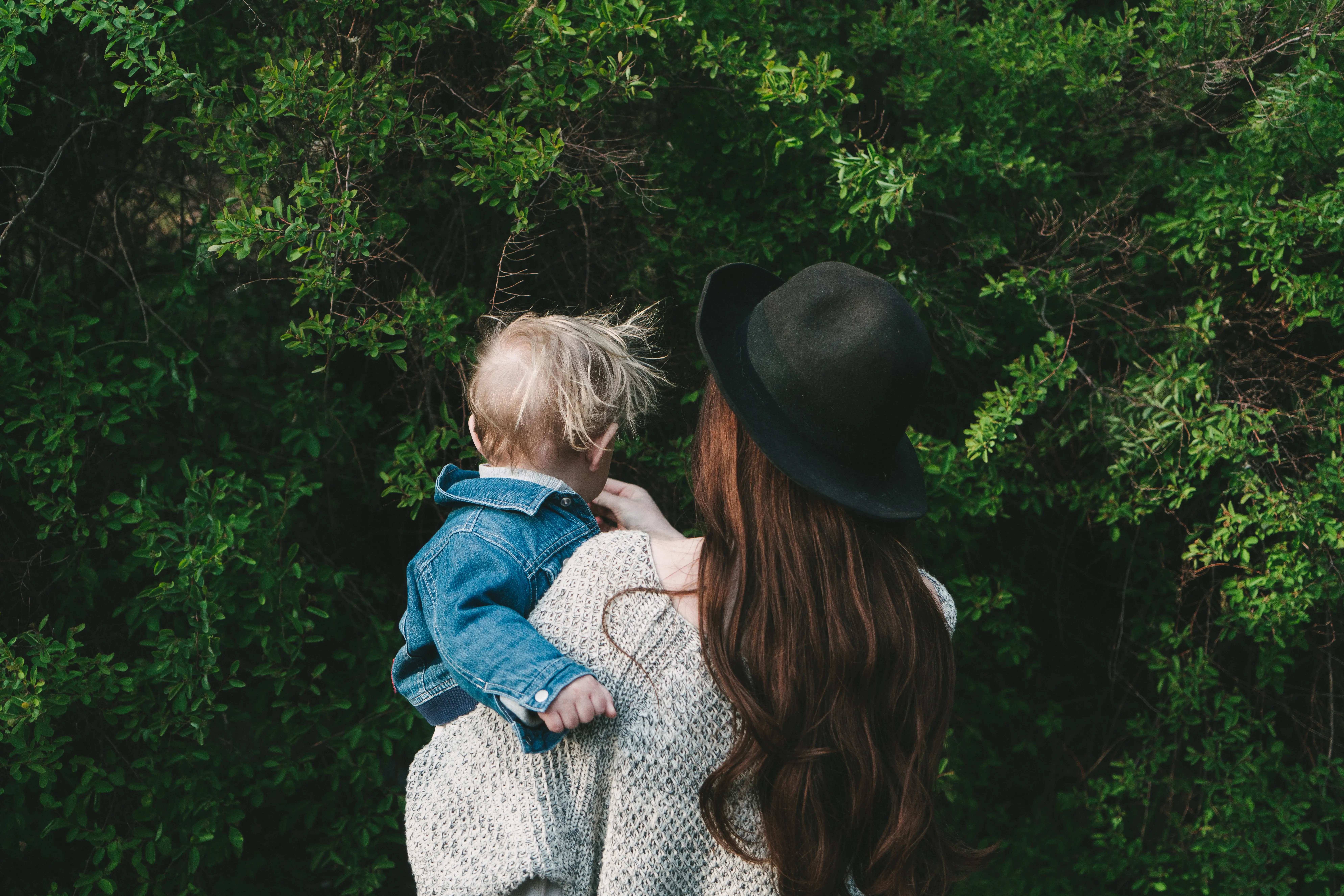 A mom holds her toddler.