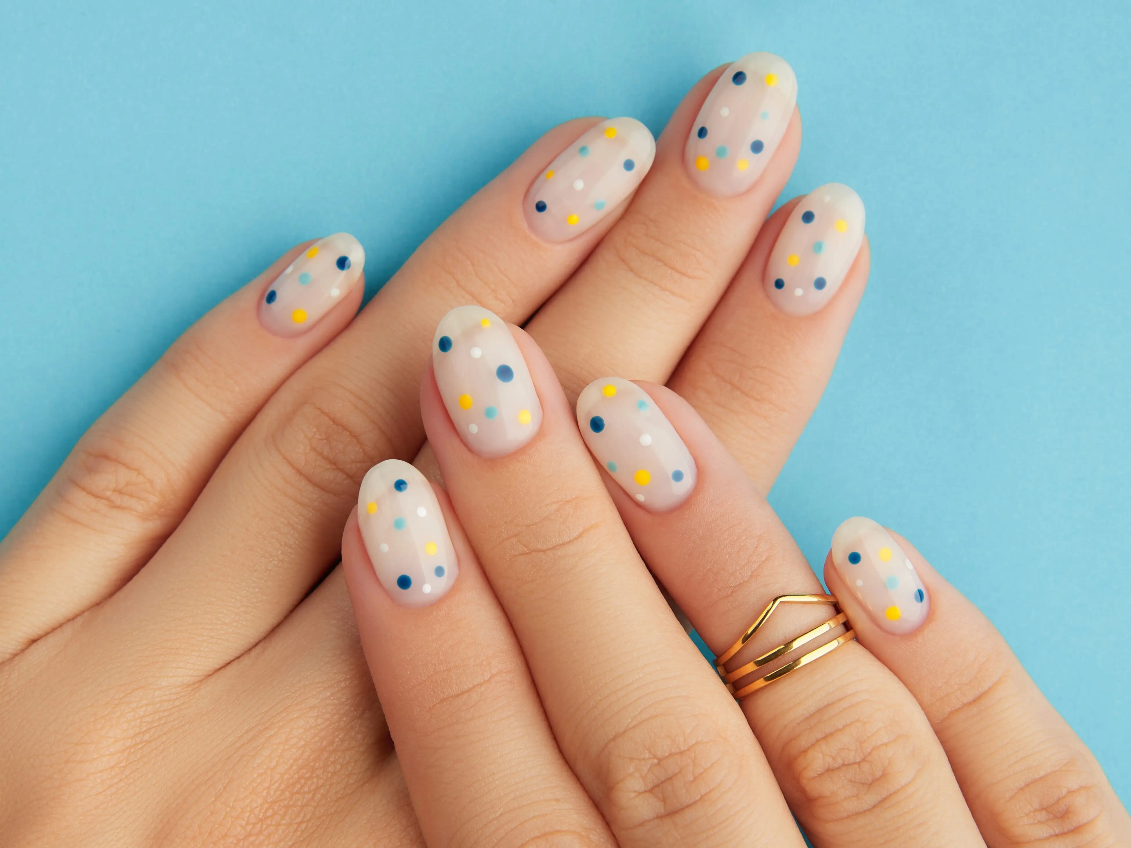 Multicolor polka dot nails.