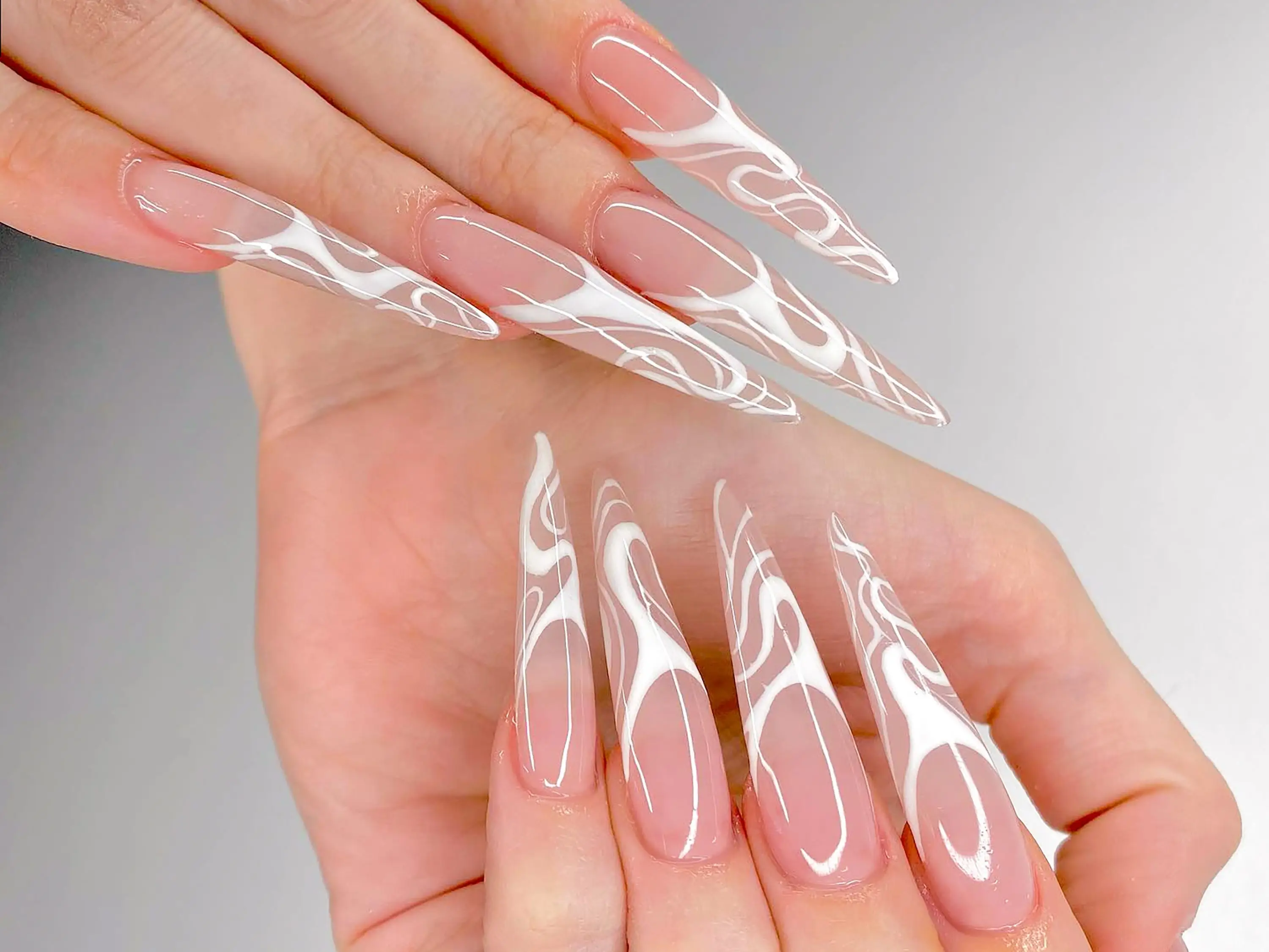 Long stiletto nails with abstract designs.