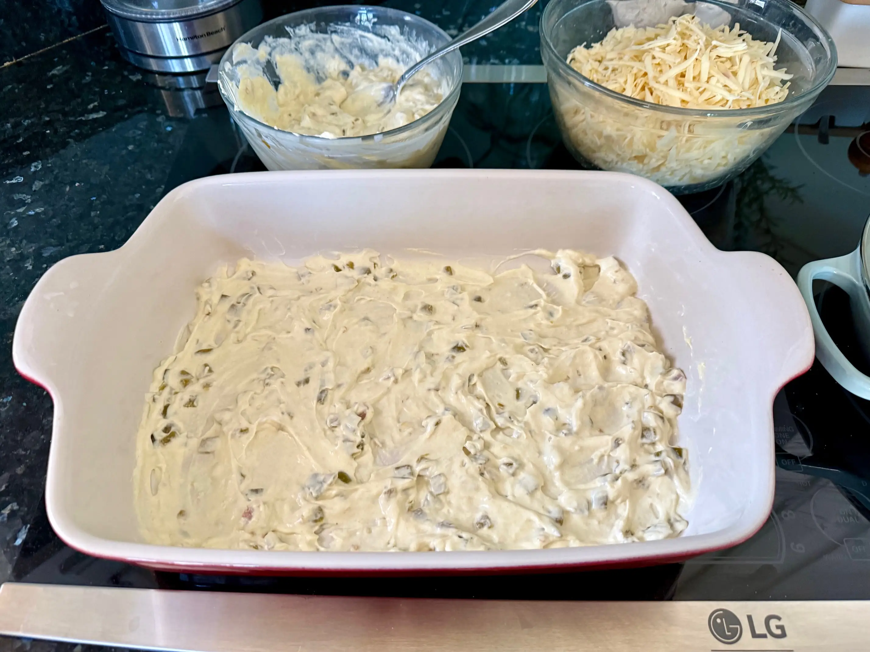 A layer of sauce on the bottom of the casserole dish.