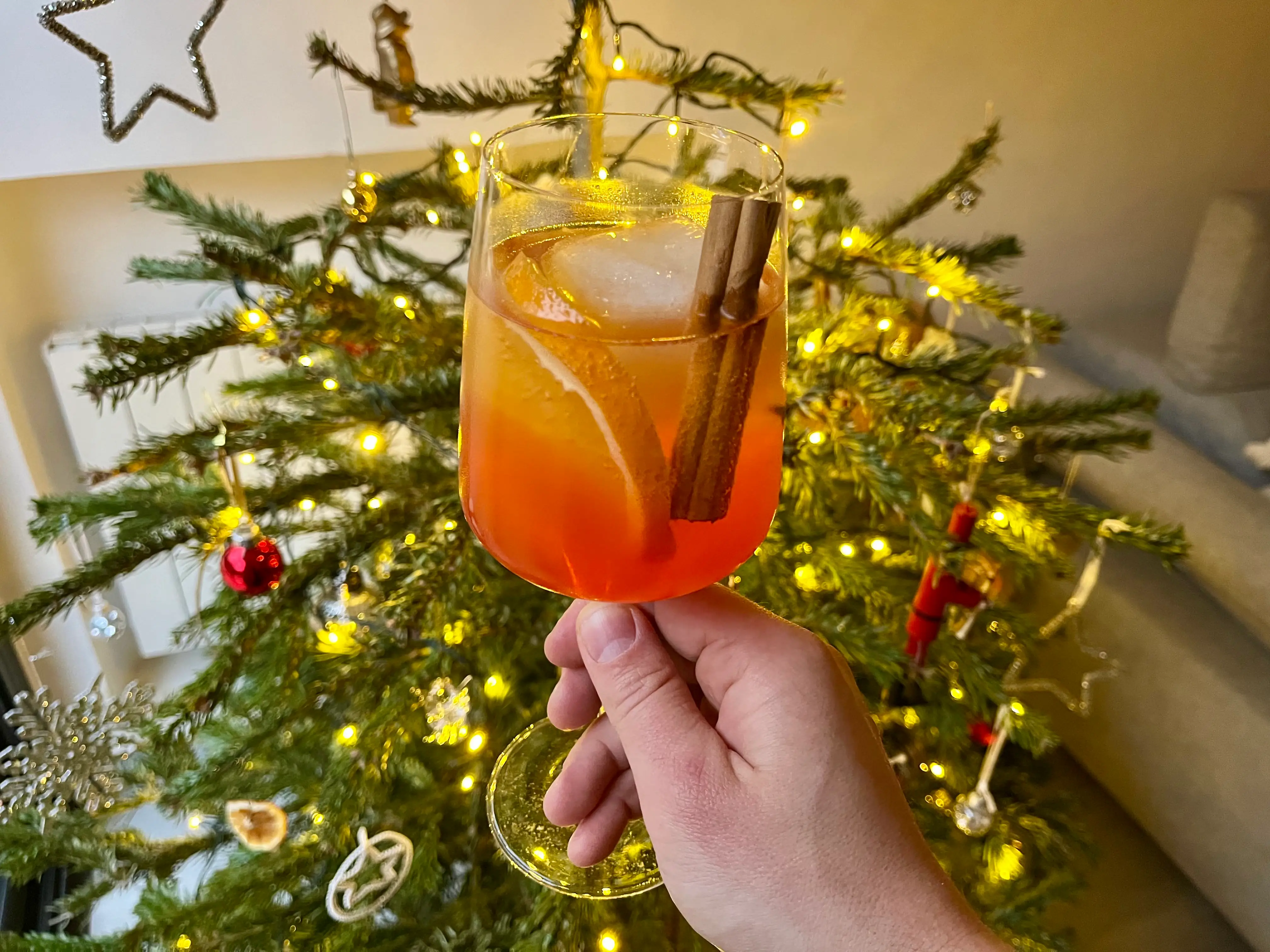 Holiday Spritz in front of Christmas tree