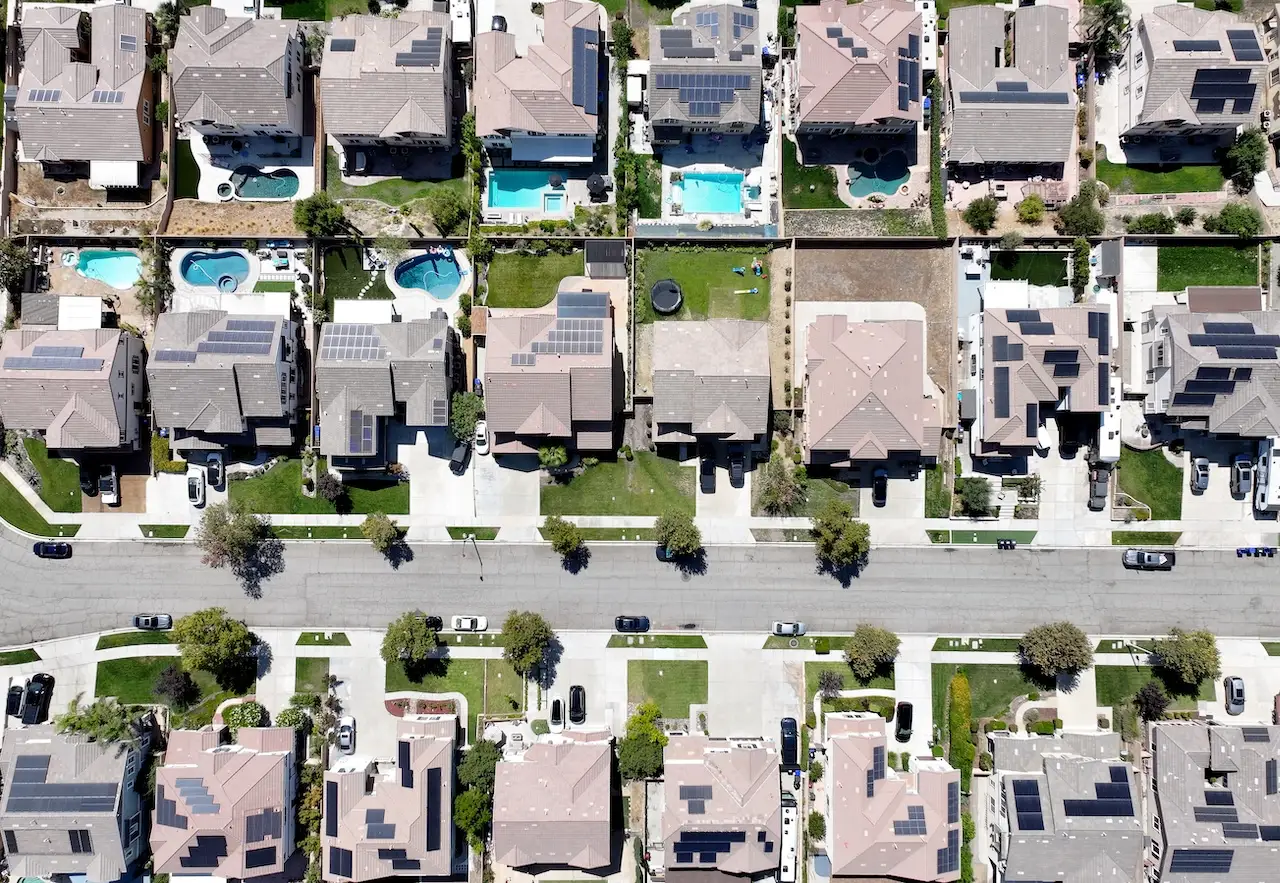 An aerial view of residential homes, many with solar panels, in Fontana, California.