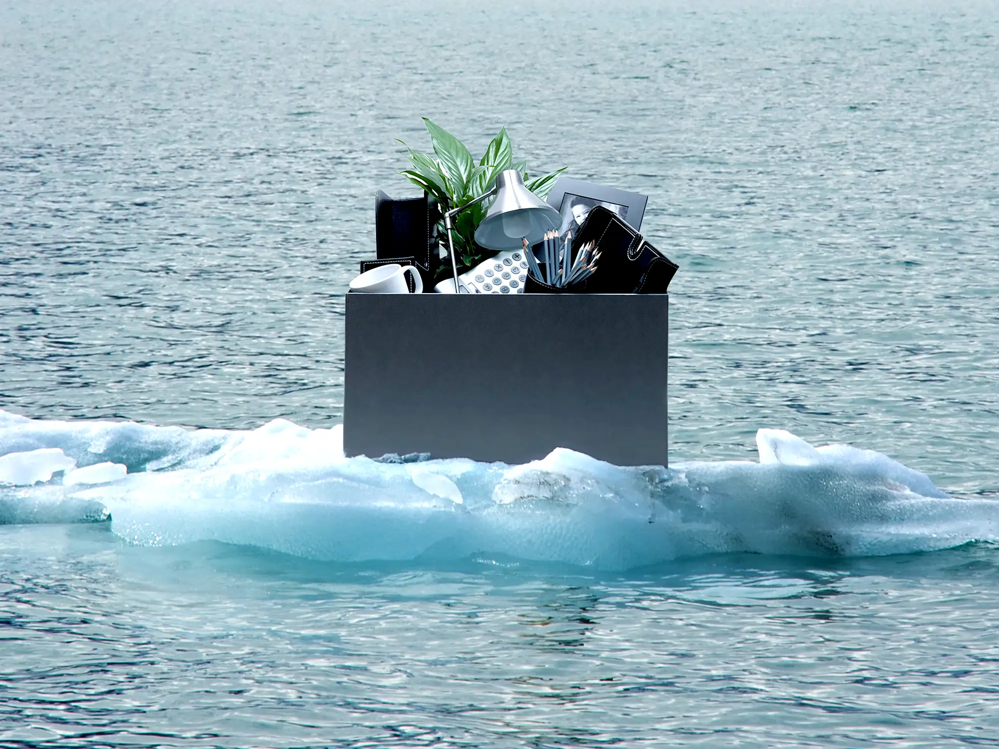 A box of office supplies in an iceberg.