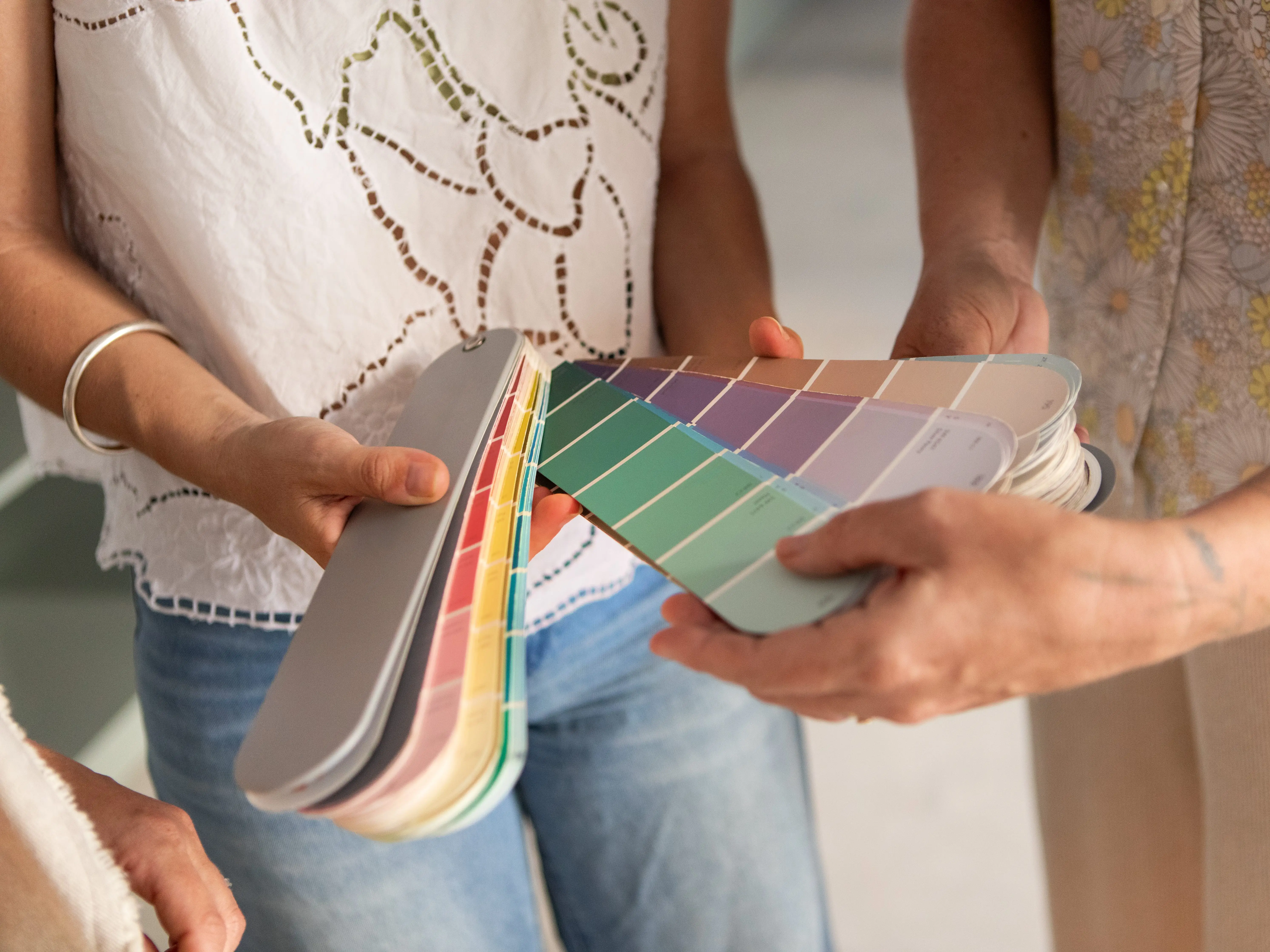 People holding paint swatches.