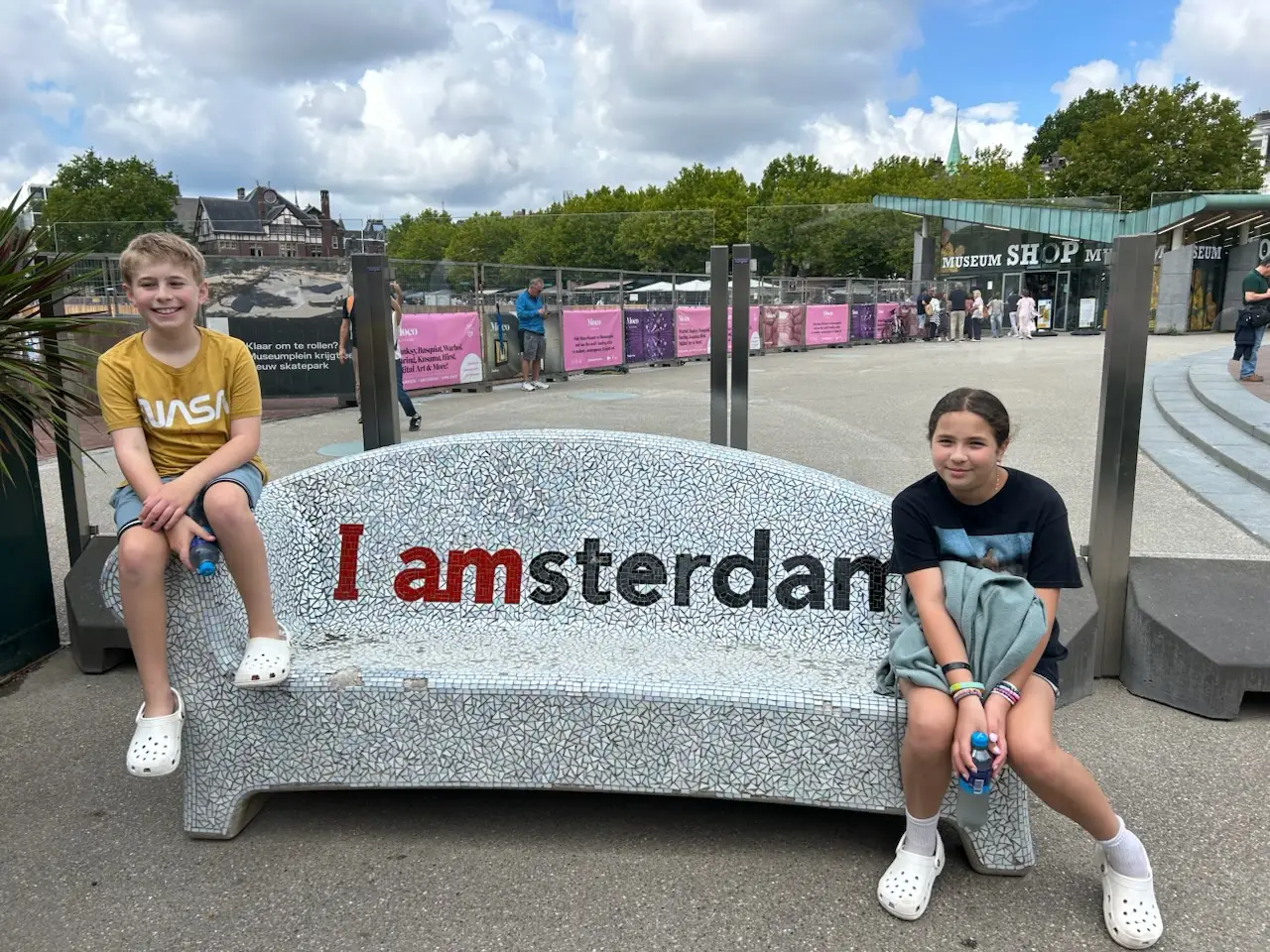 Kids smiling with Amsterdam bench