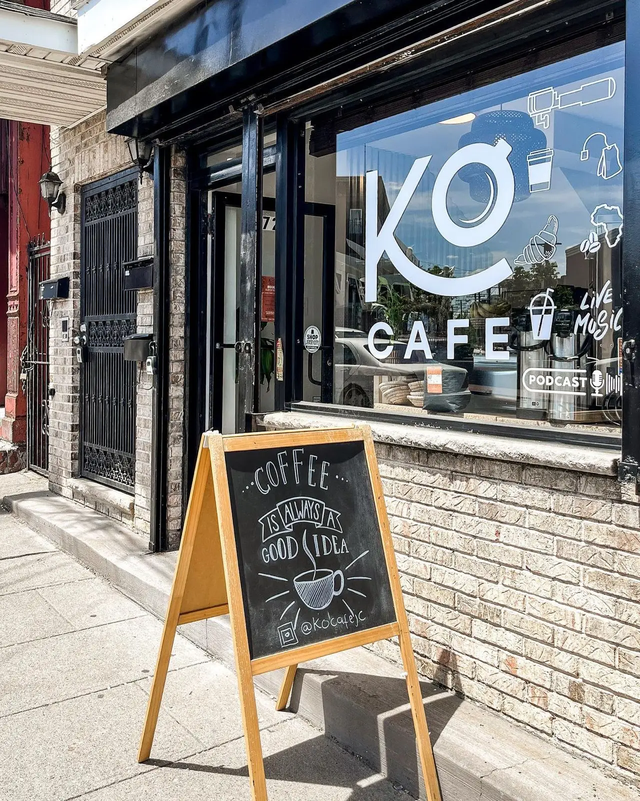 A coffee sign in front of the Ko Cafe store front.