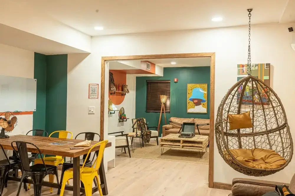 A dining table and a glimpse of the podcast room inside the café.