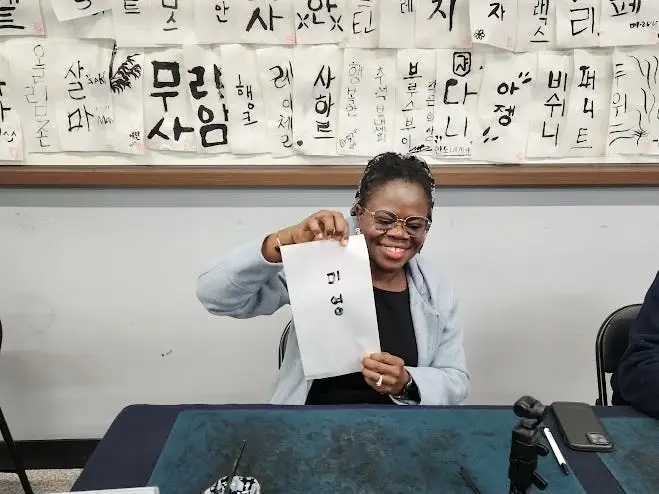 A woman posing with calligrpahy.