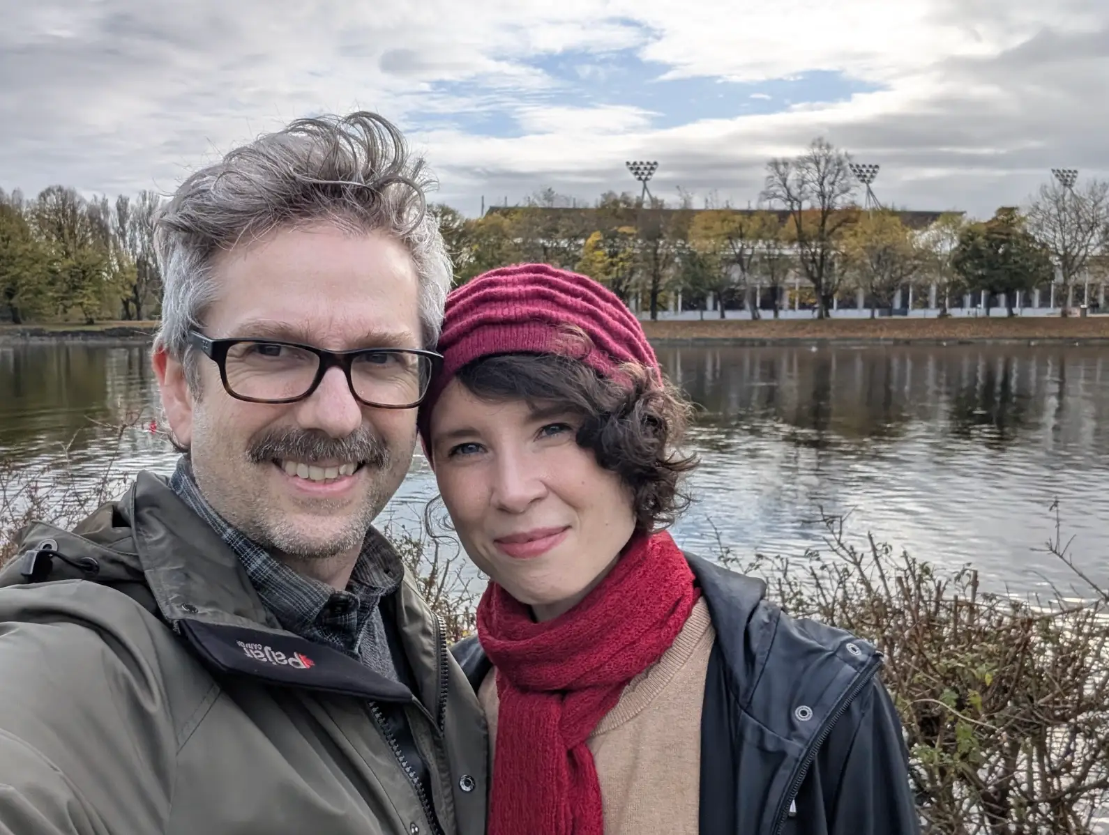 The writer and her husband standing in front of a pond.