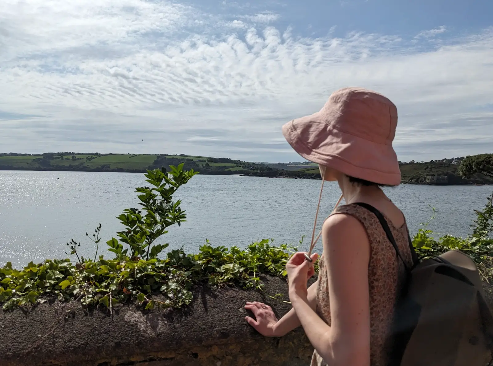 The writer standing in front of the water in Ireland.