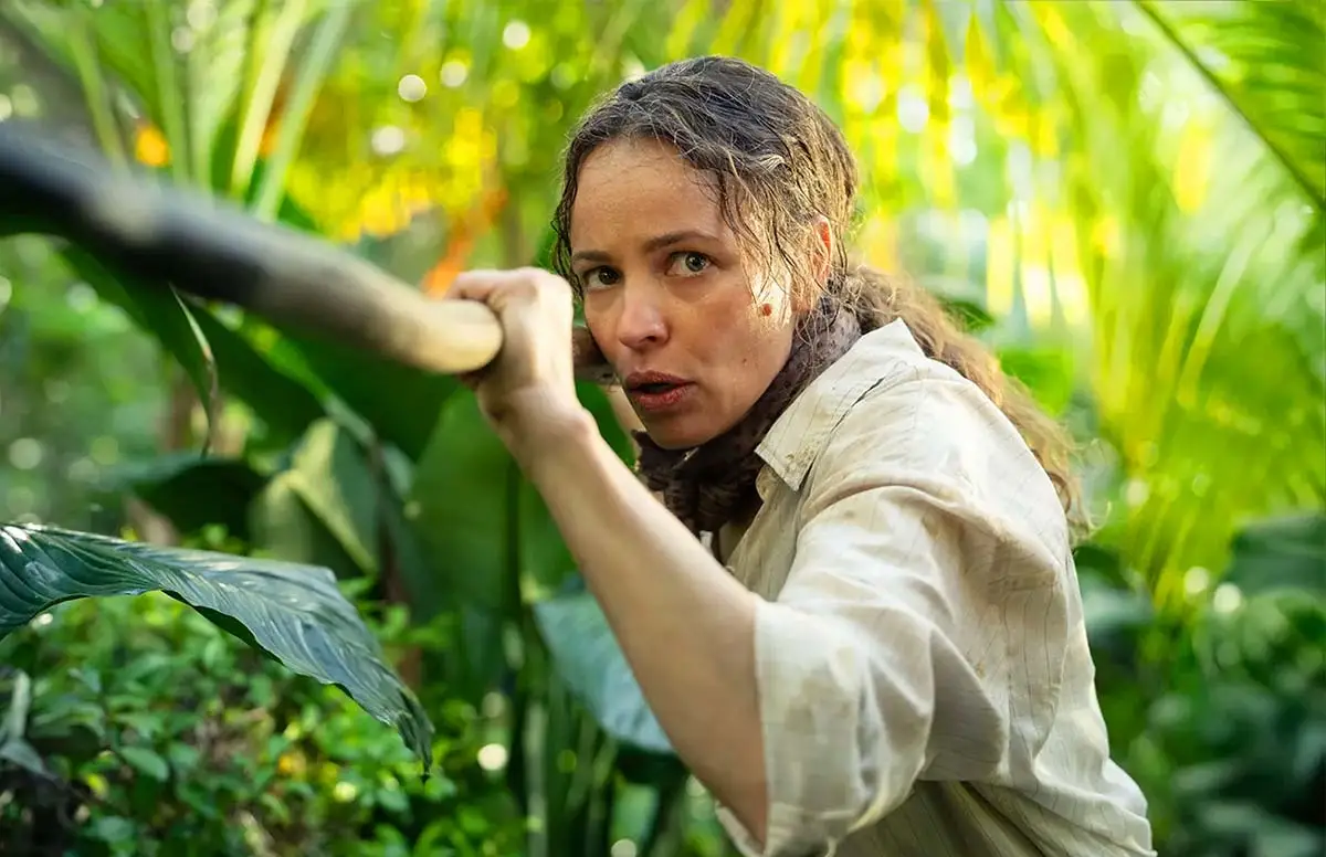 Rachel McAdams holding a stick in the jungle