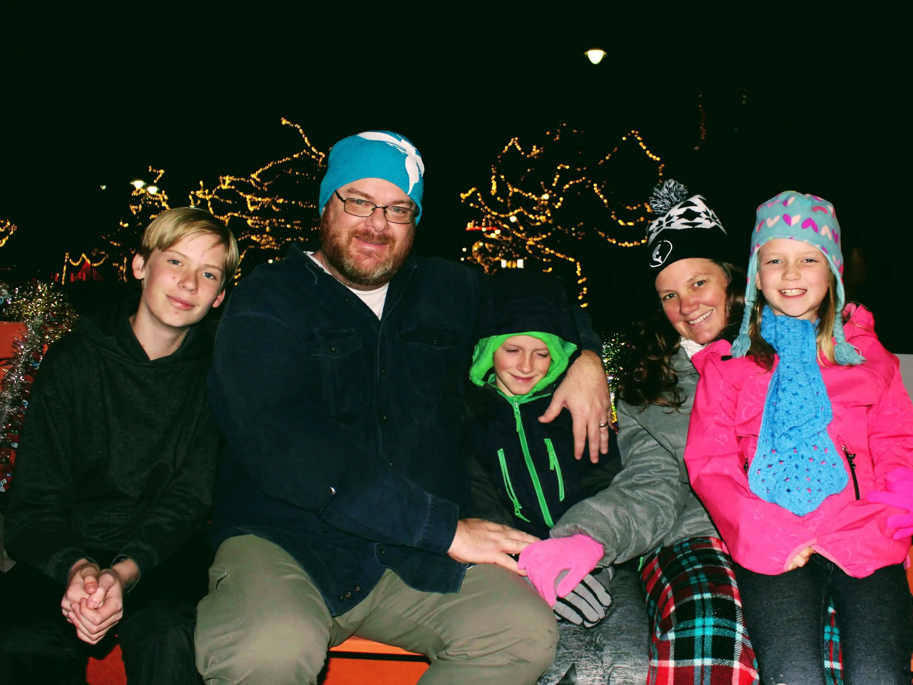 The author and her family pose in front of a Christmas light display.