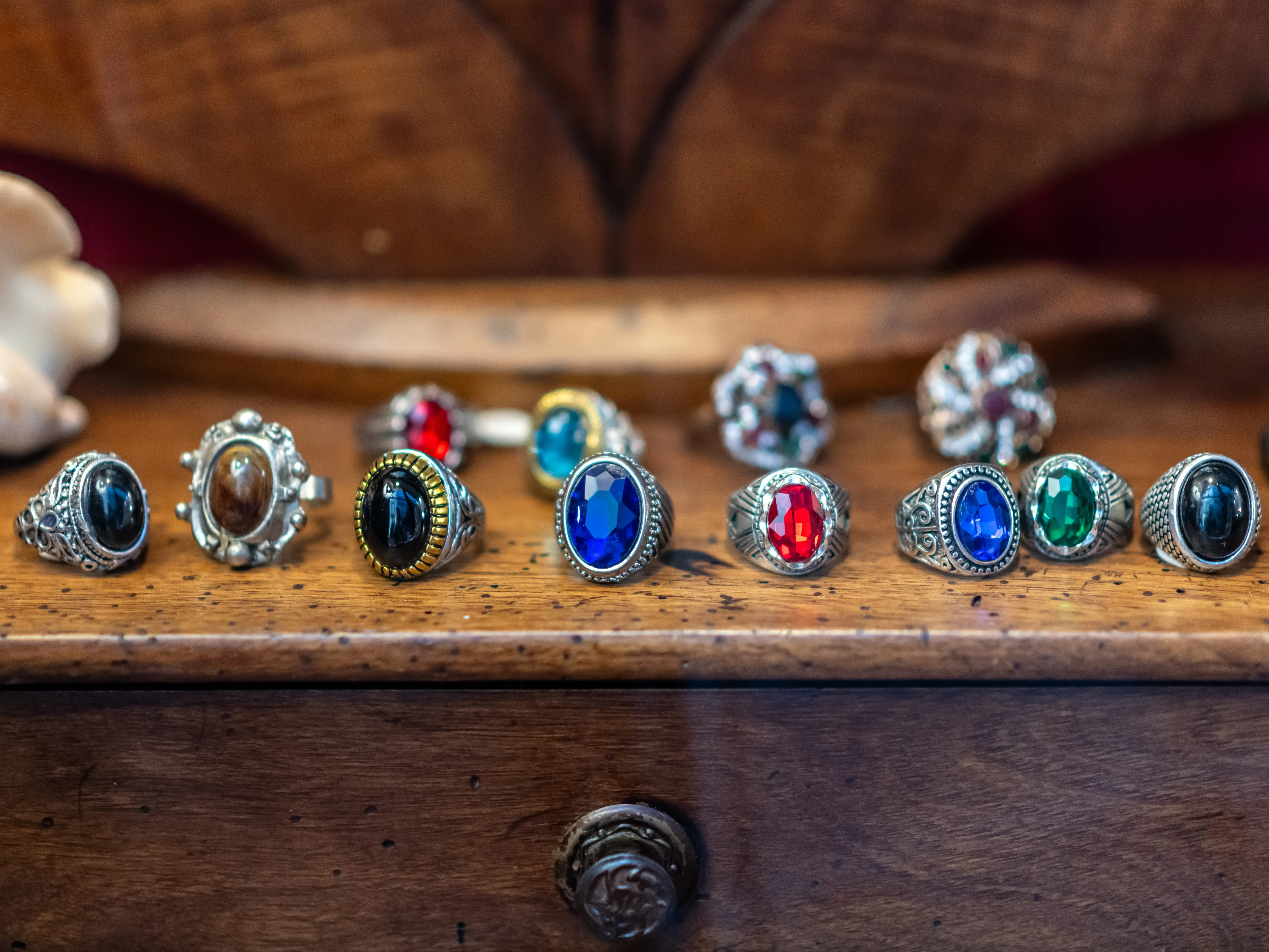 Vintage, colorful rings in a line on a table.