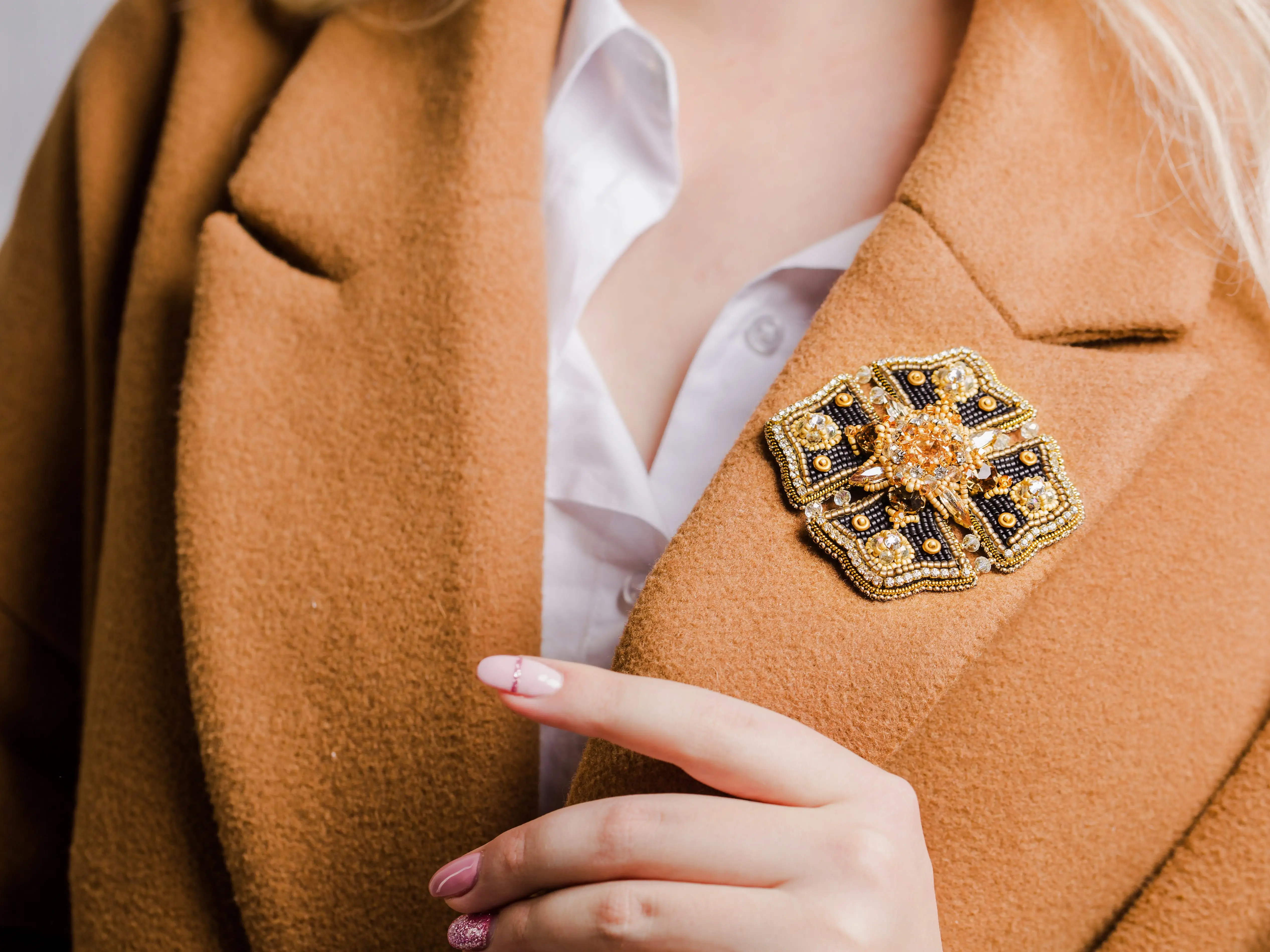 A woman with a brooch on her jacket.