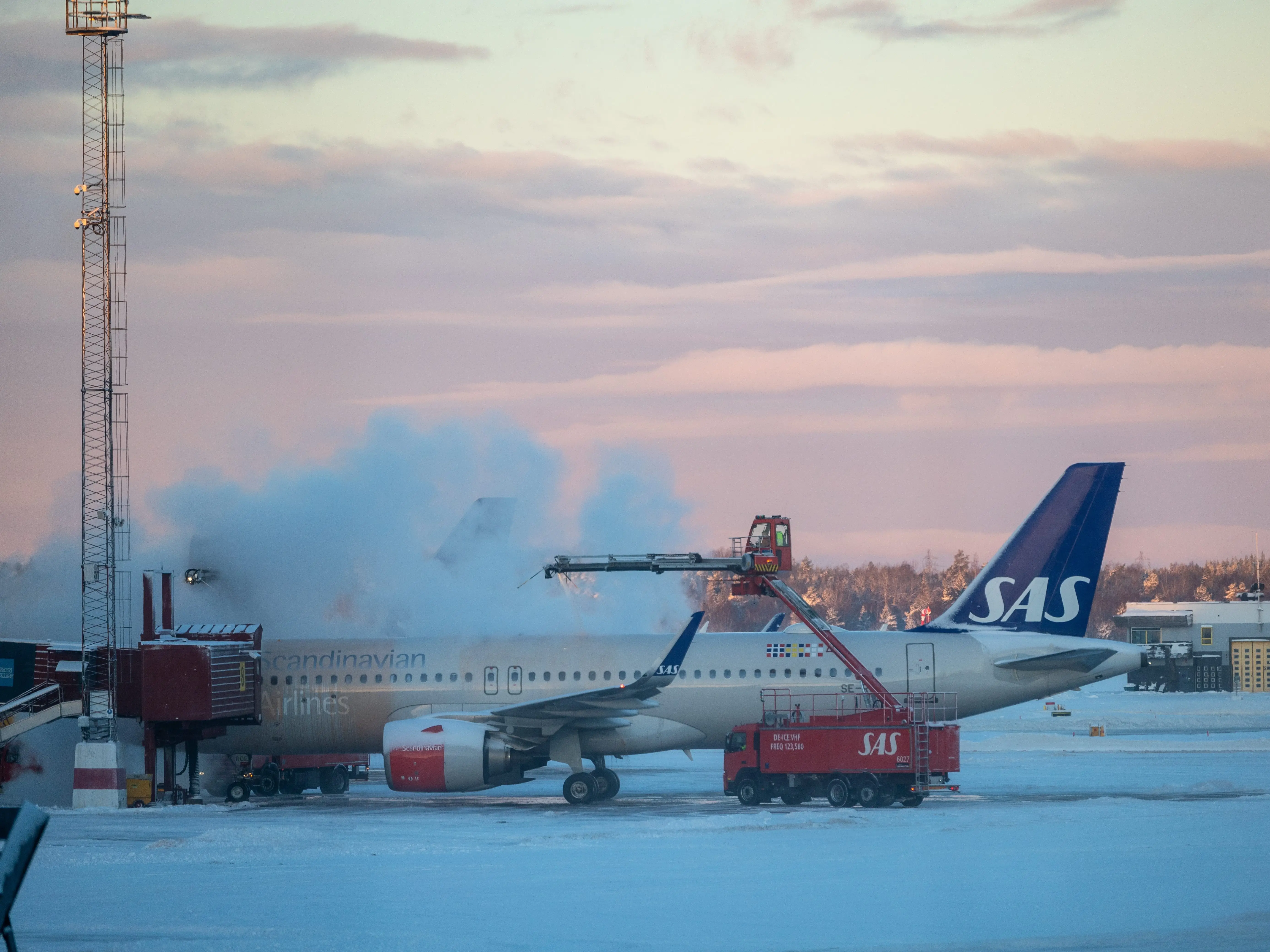 A SAS plane getting de-iced at stockholm airport.