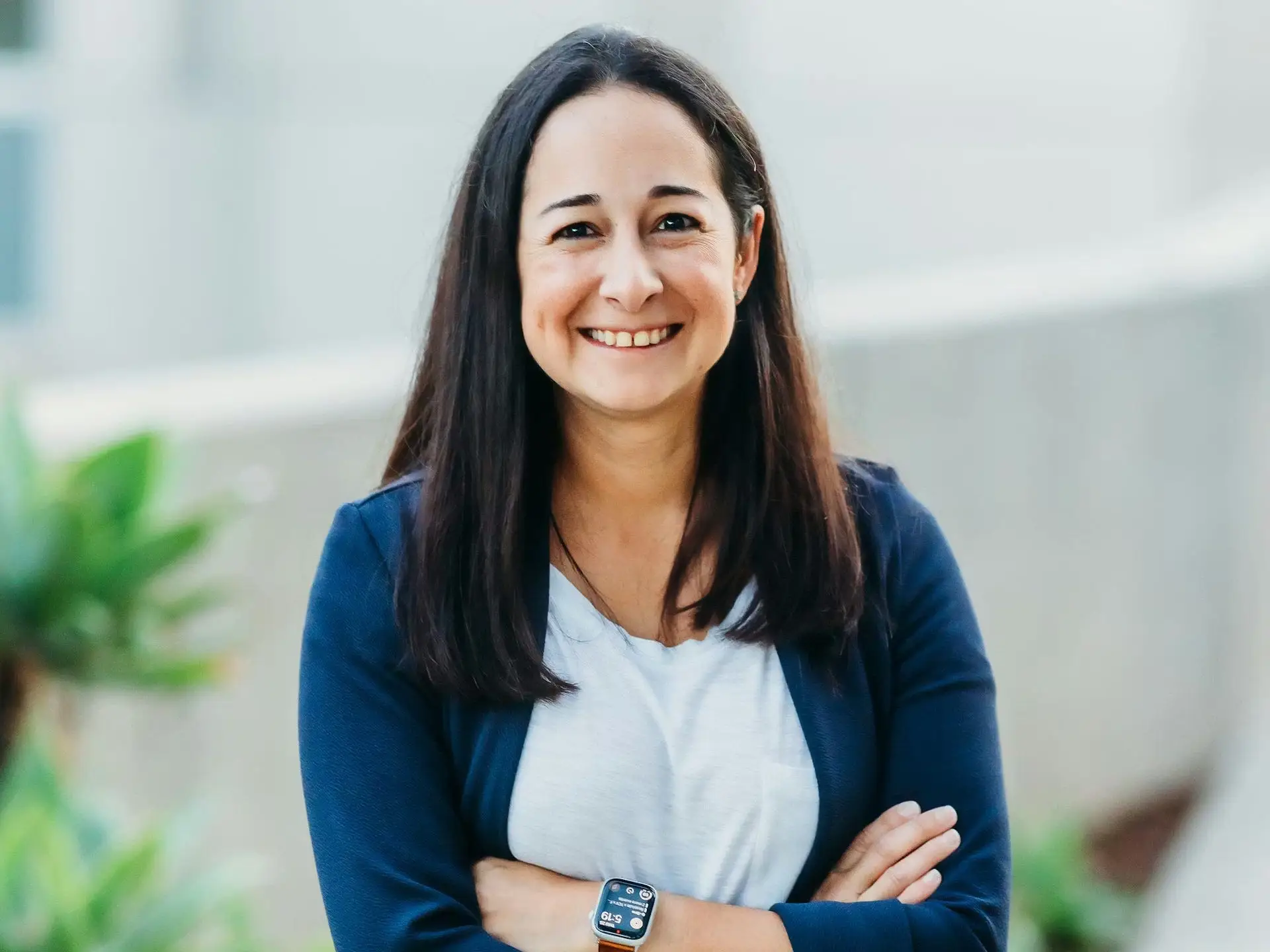 Monica Black smiles for a photo with arms folded across her chest.