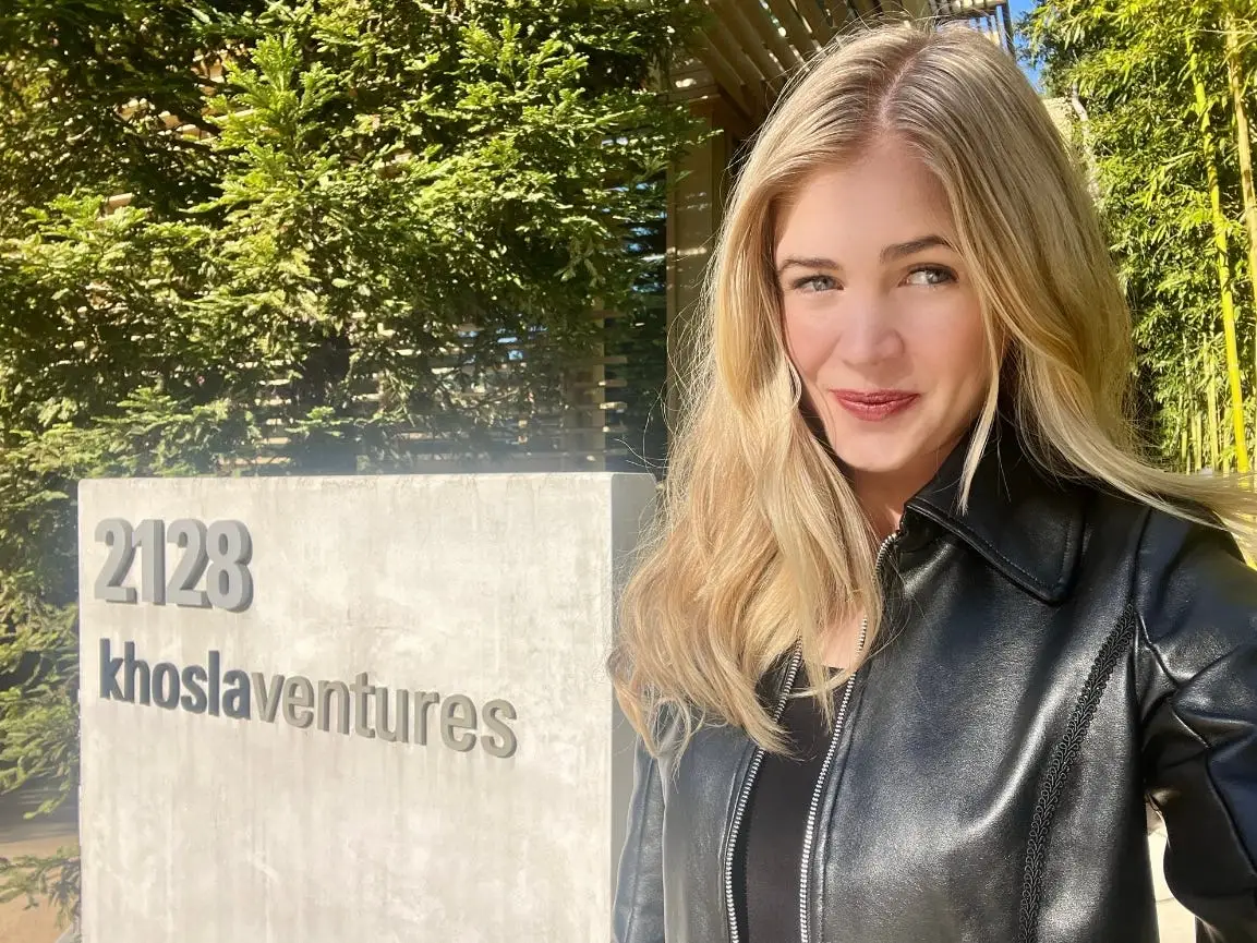 Katie Mishra snaps a photo in front of a Khosla Ventures sign.