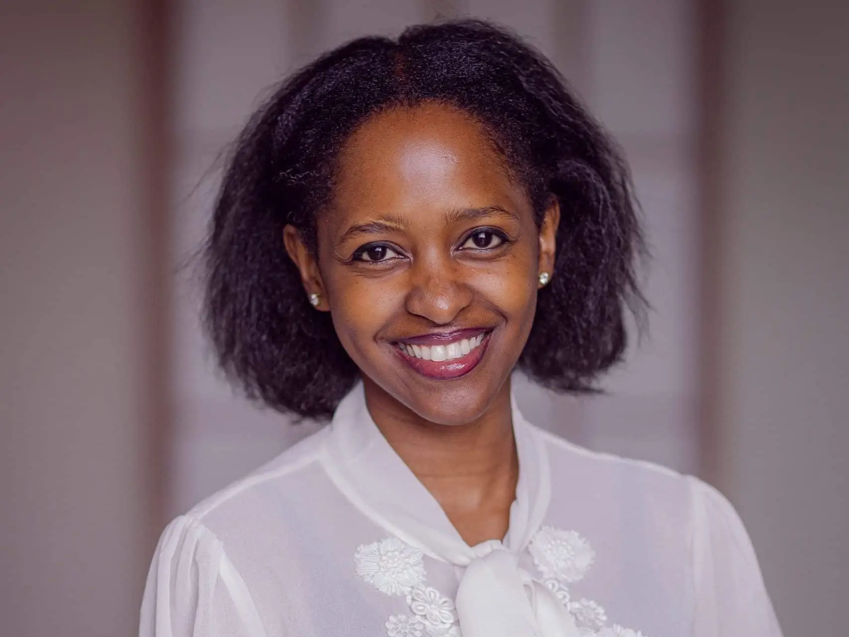 Shamillah Bankiya sits for a portrait wearing a white blouse.