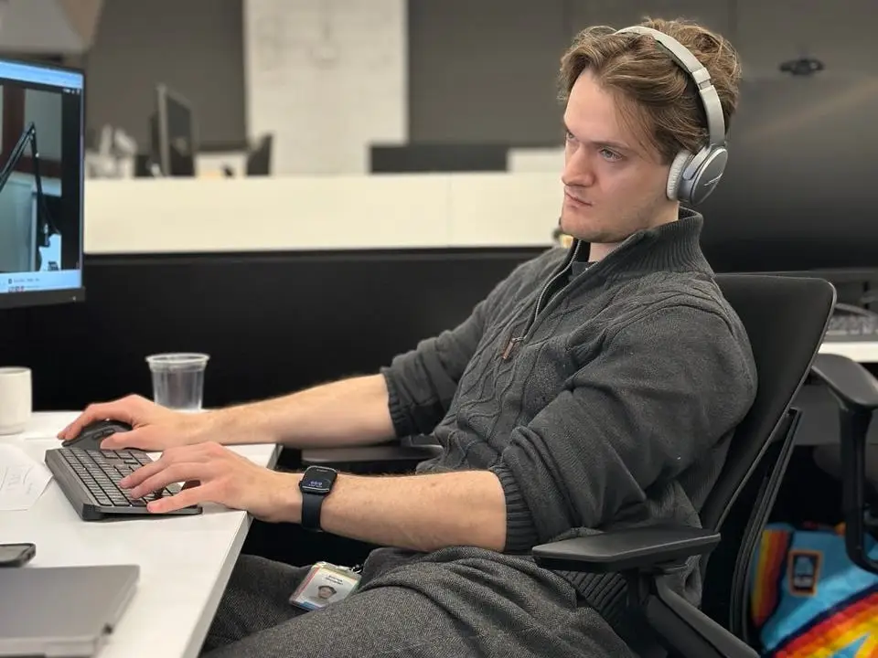 Emrick Donadei looking at computer