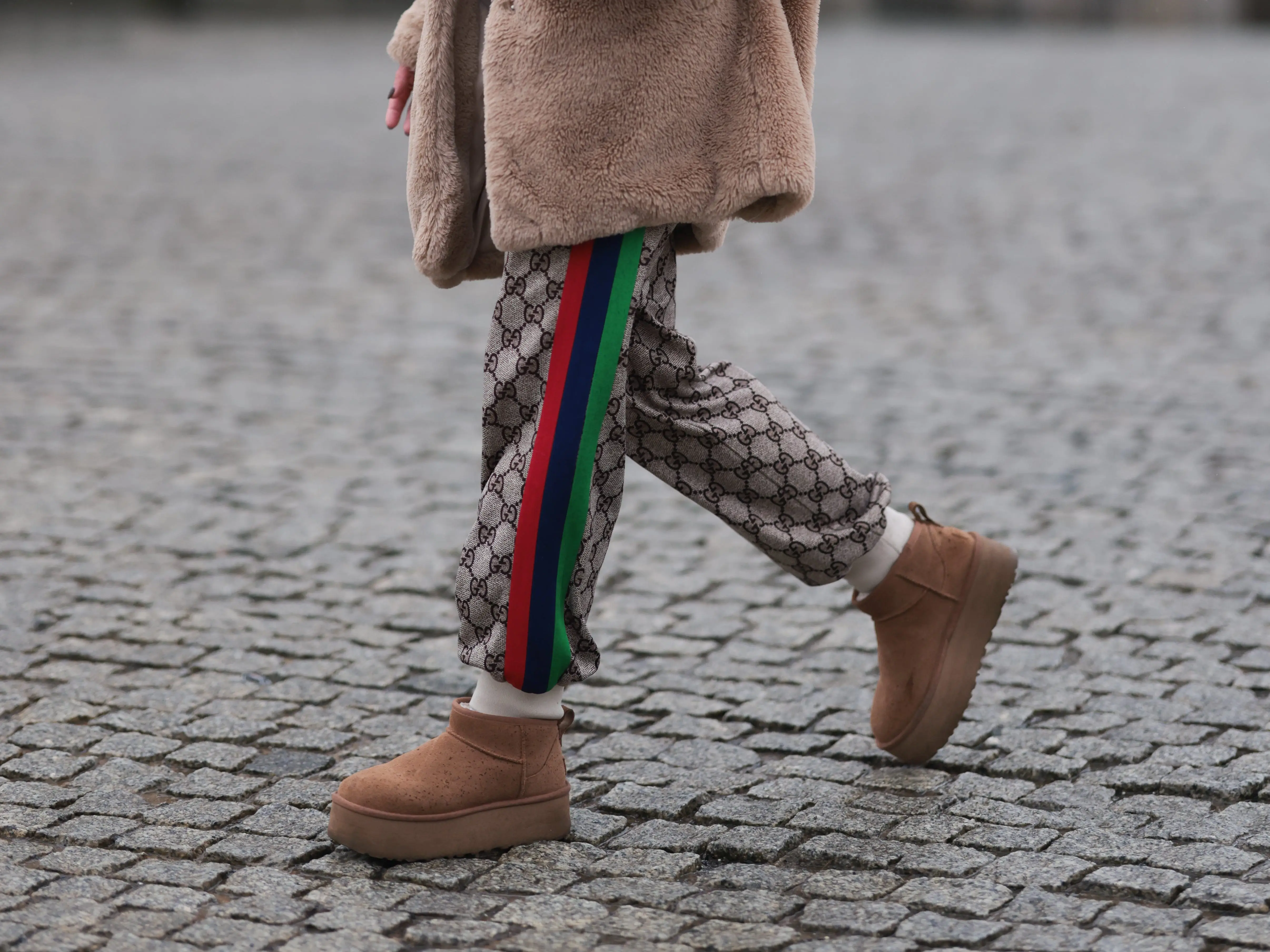 An influencer wears micro Ugg slippers.