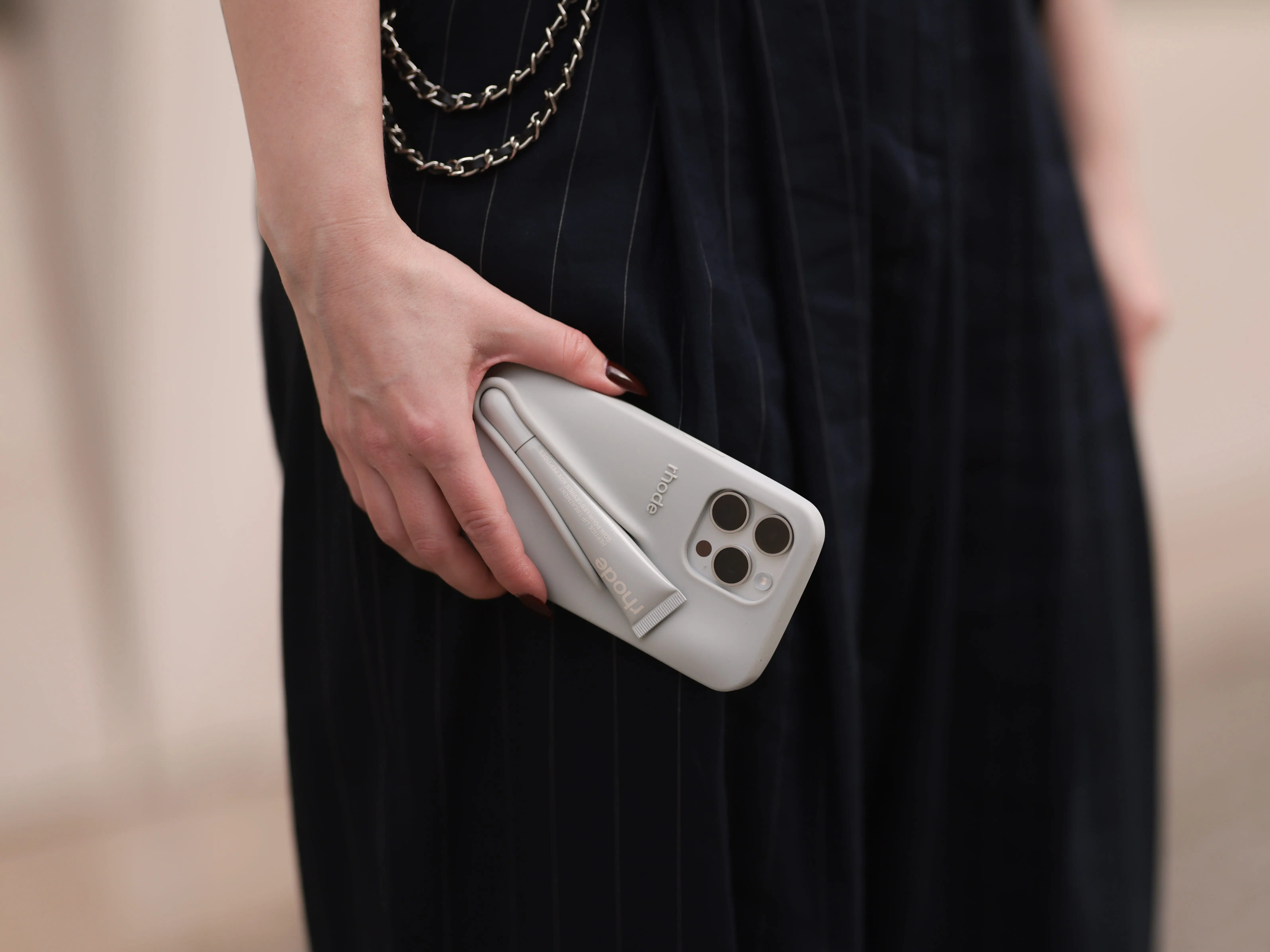 Maria Barteczko holds her phone, which is encased in a Rhode lip-gloss holder, in Berlin.