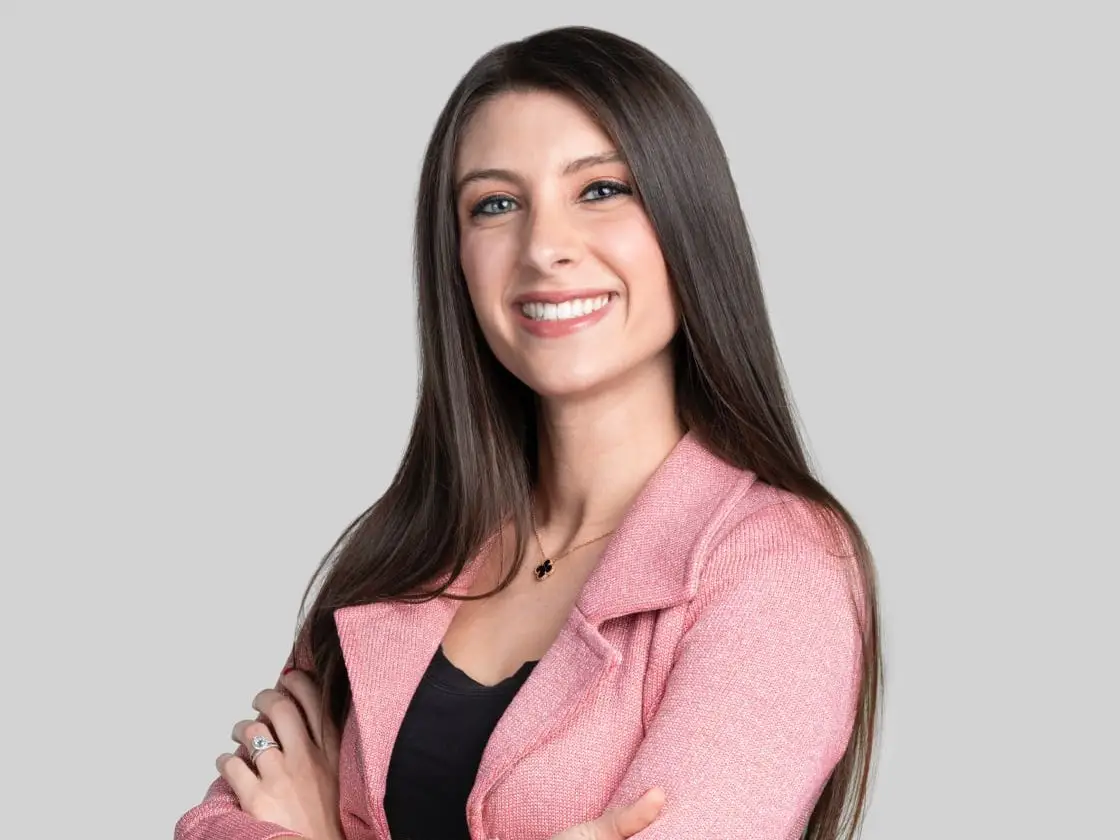 Mary D'Onofrio, a partner at Bessemer Venture Partners, smiles for a photo against a gray background.
