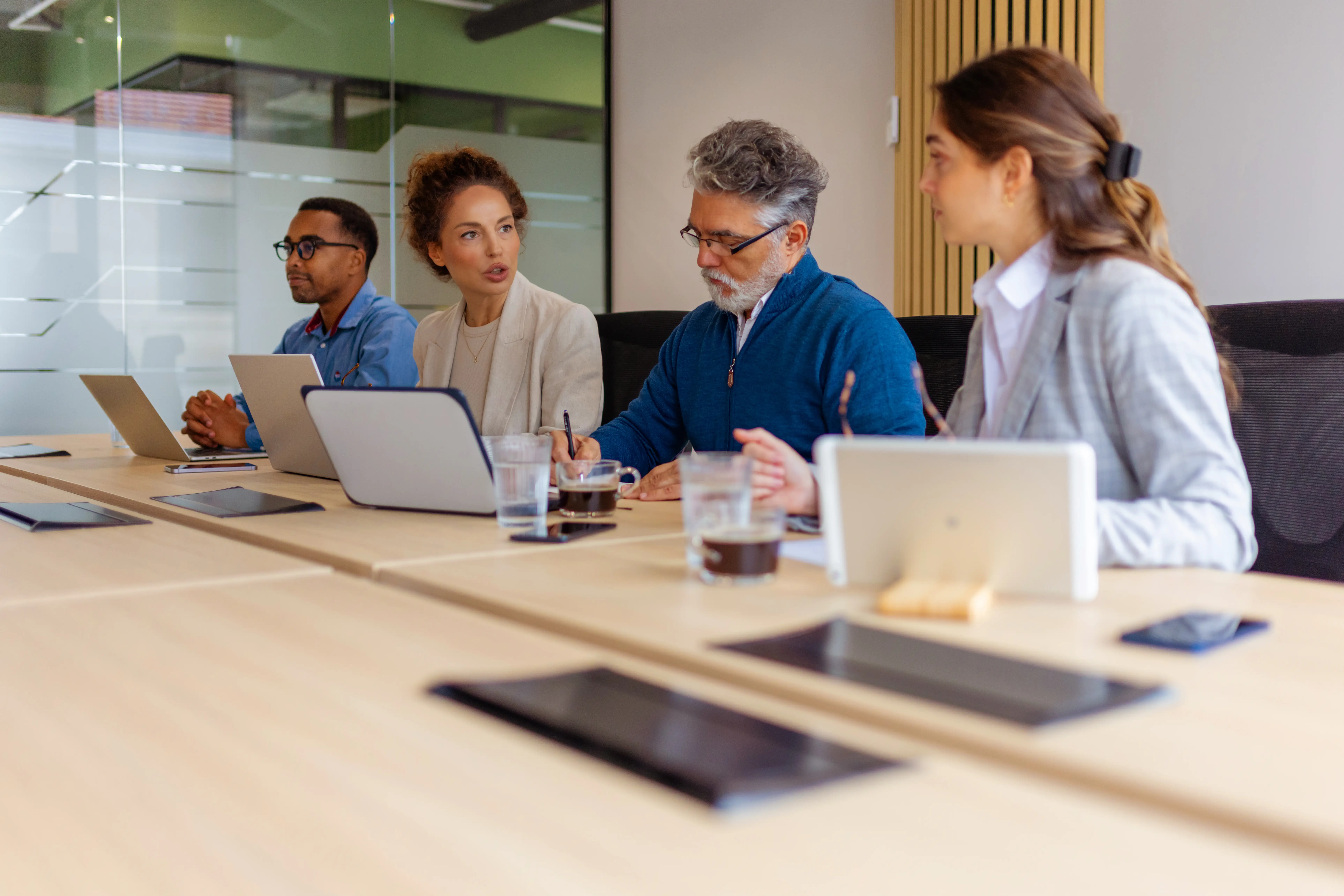 four people in a work meeting