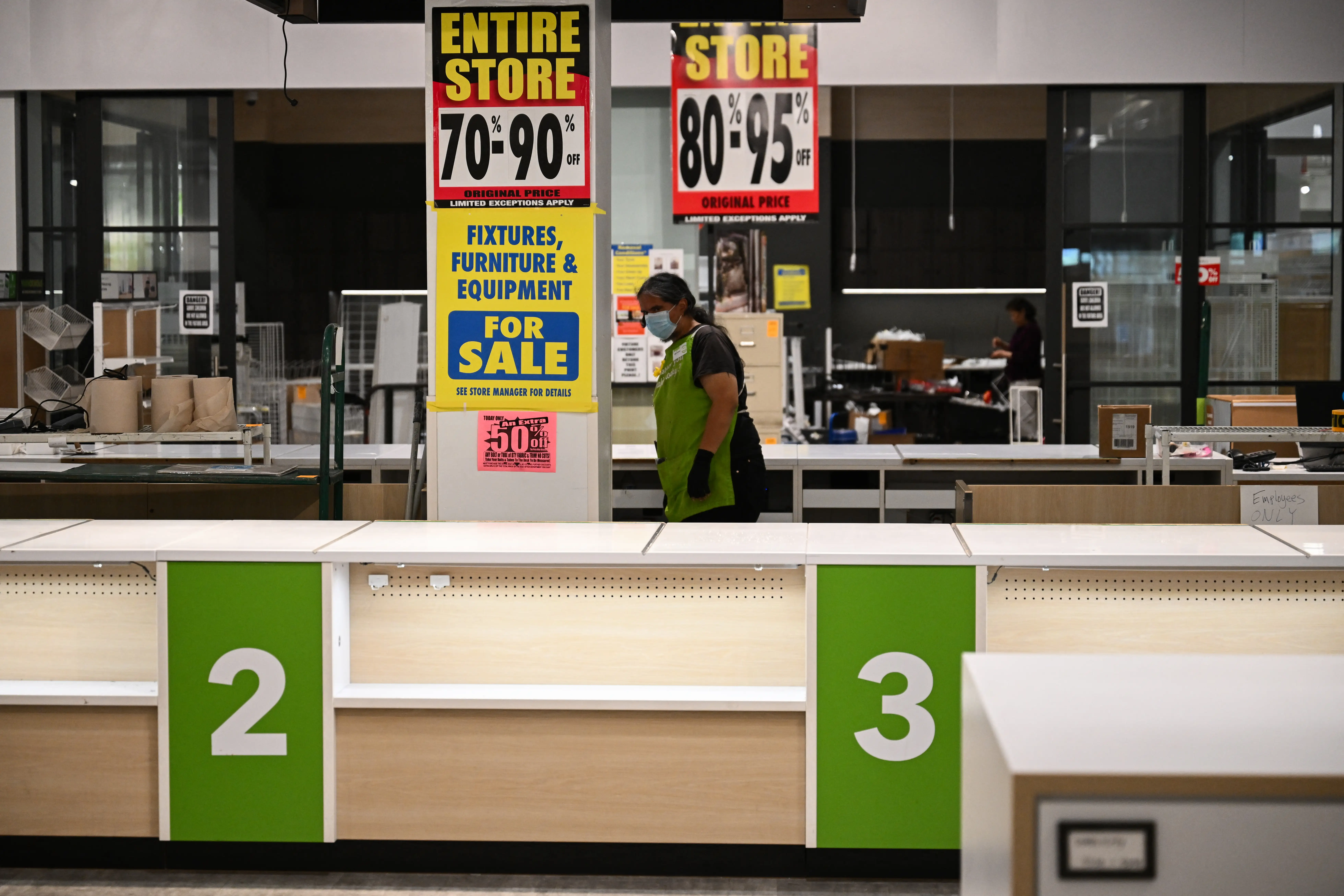 an employee looking around a closing store