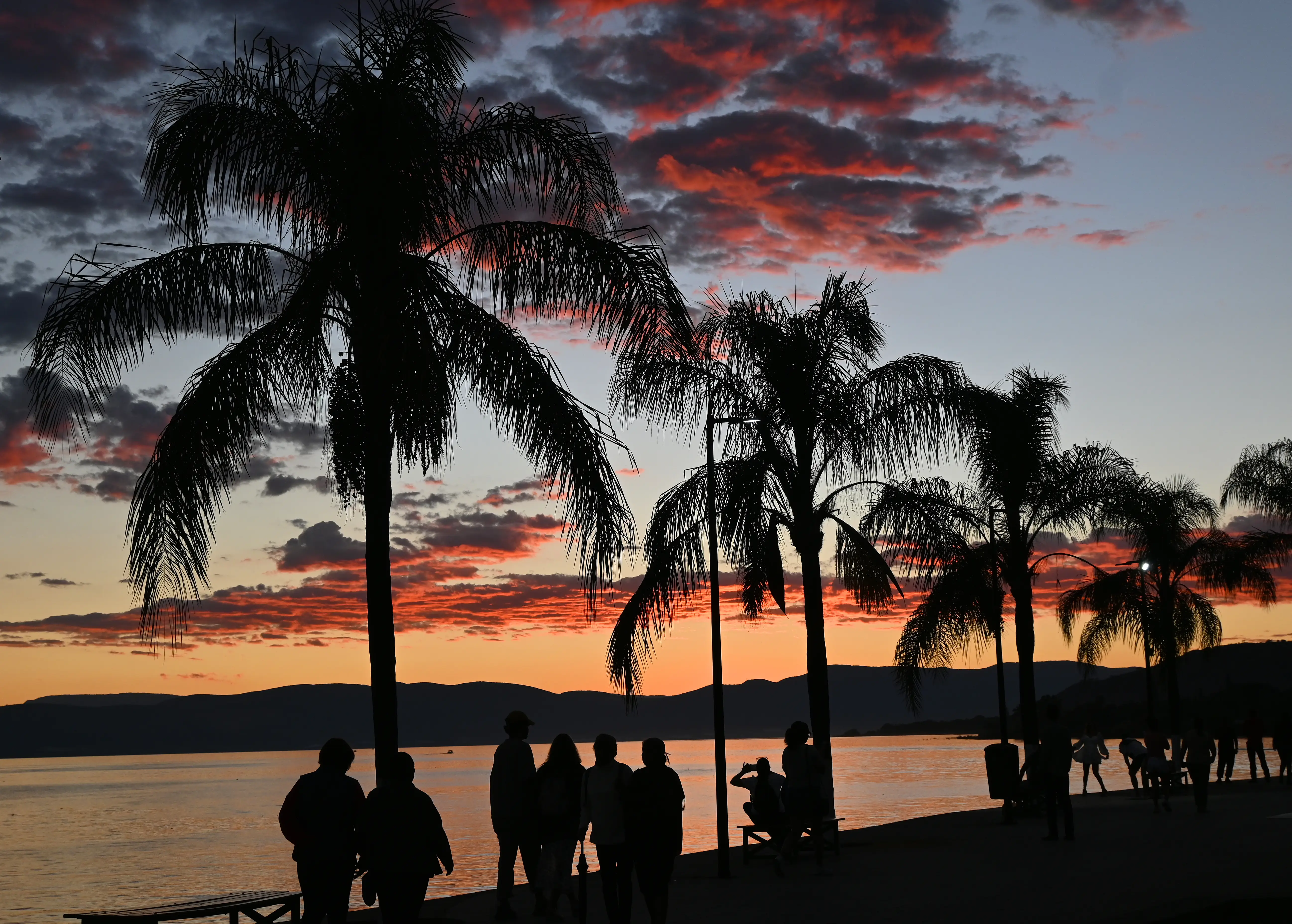 People in Ajijic, Mexico watching sunset over Lake Chapala.