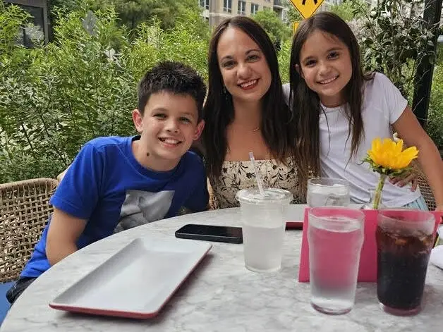 Isobella Jade (center) sits with her son (left) and daughter (right)