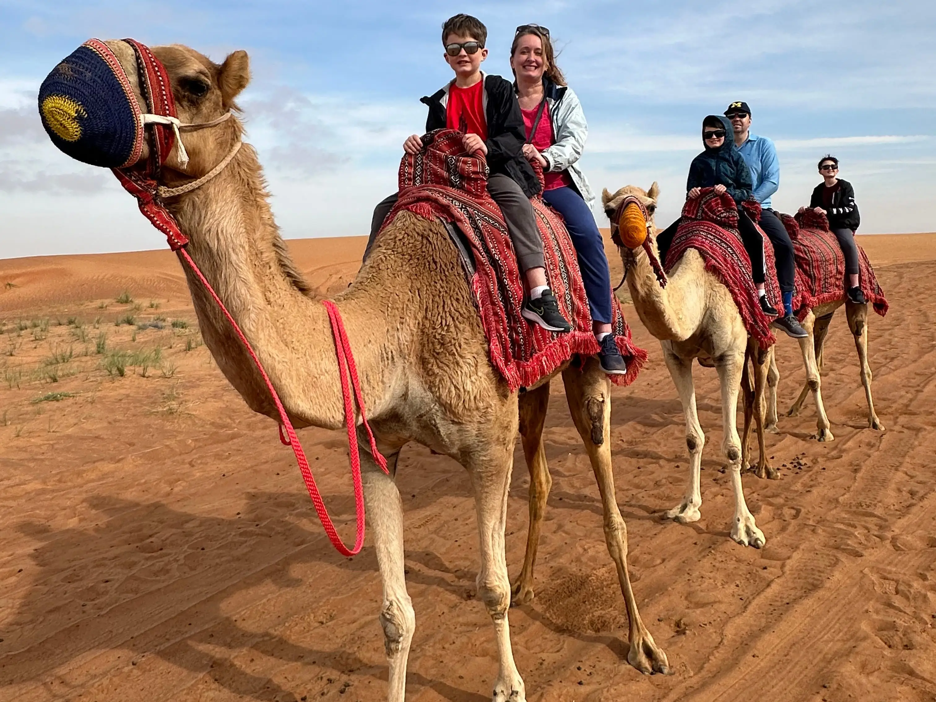 Author and her family riding camels in Dubai
