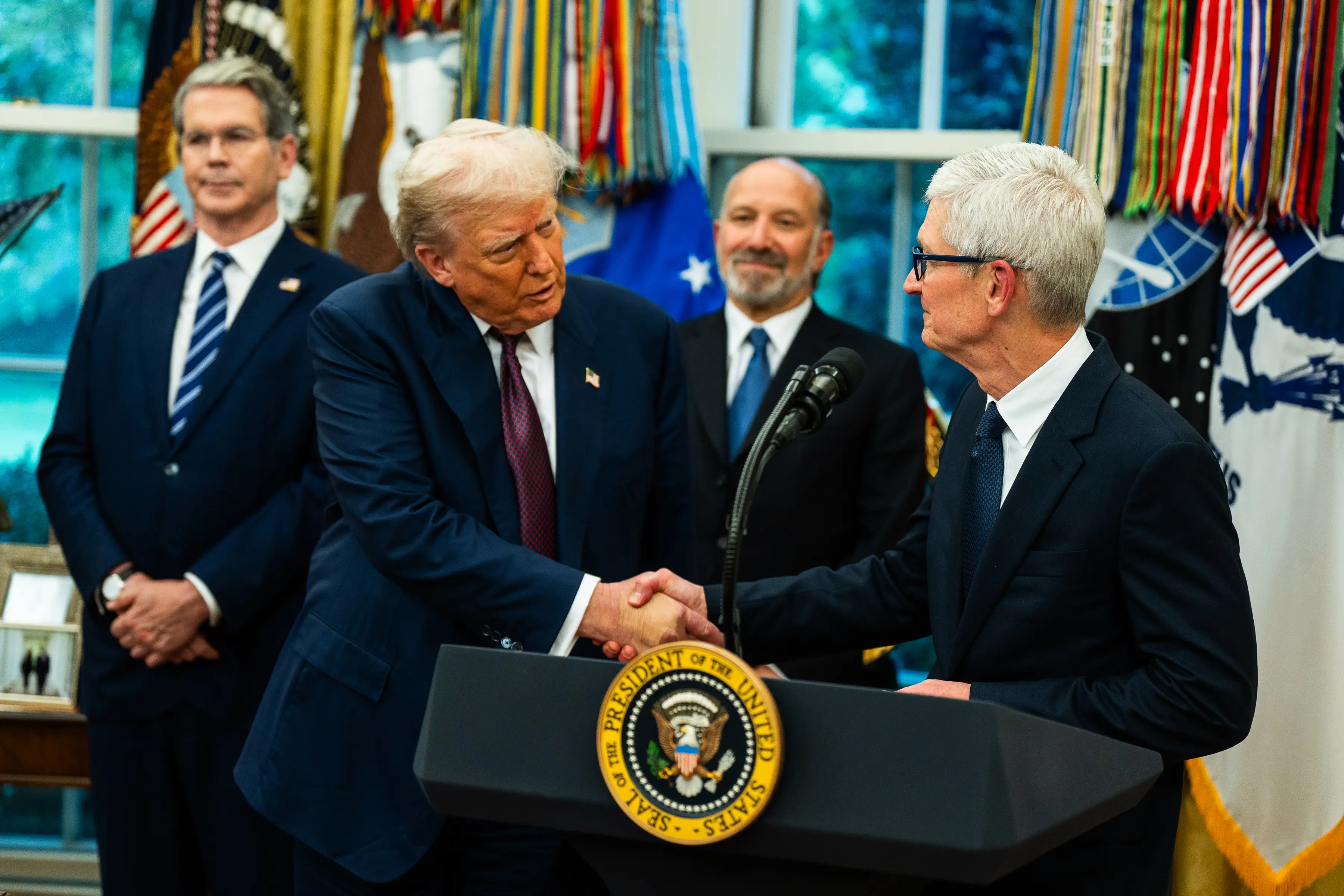 Donald Trump shaking hands with Tim Cook