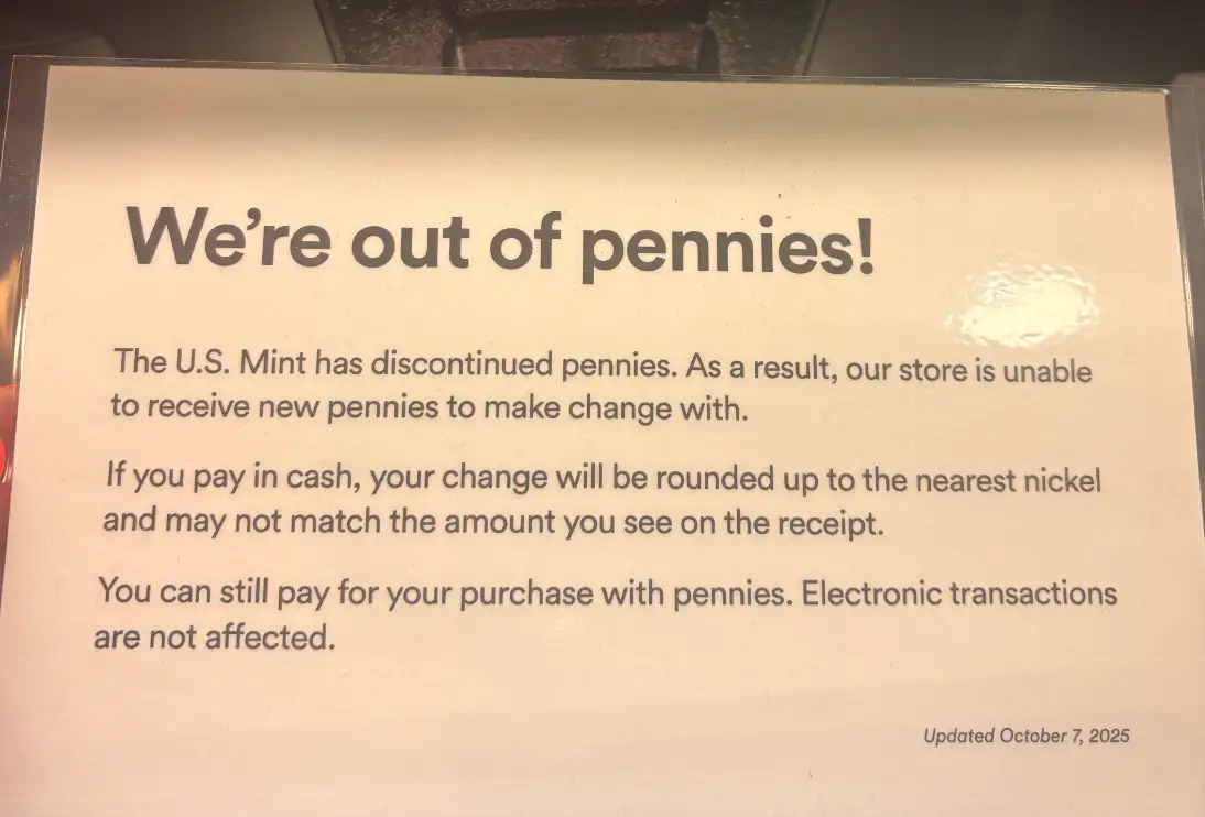 A laminated sign at a Whole Foods checkout in New York City reads: 