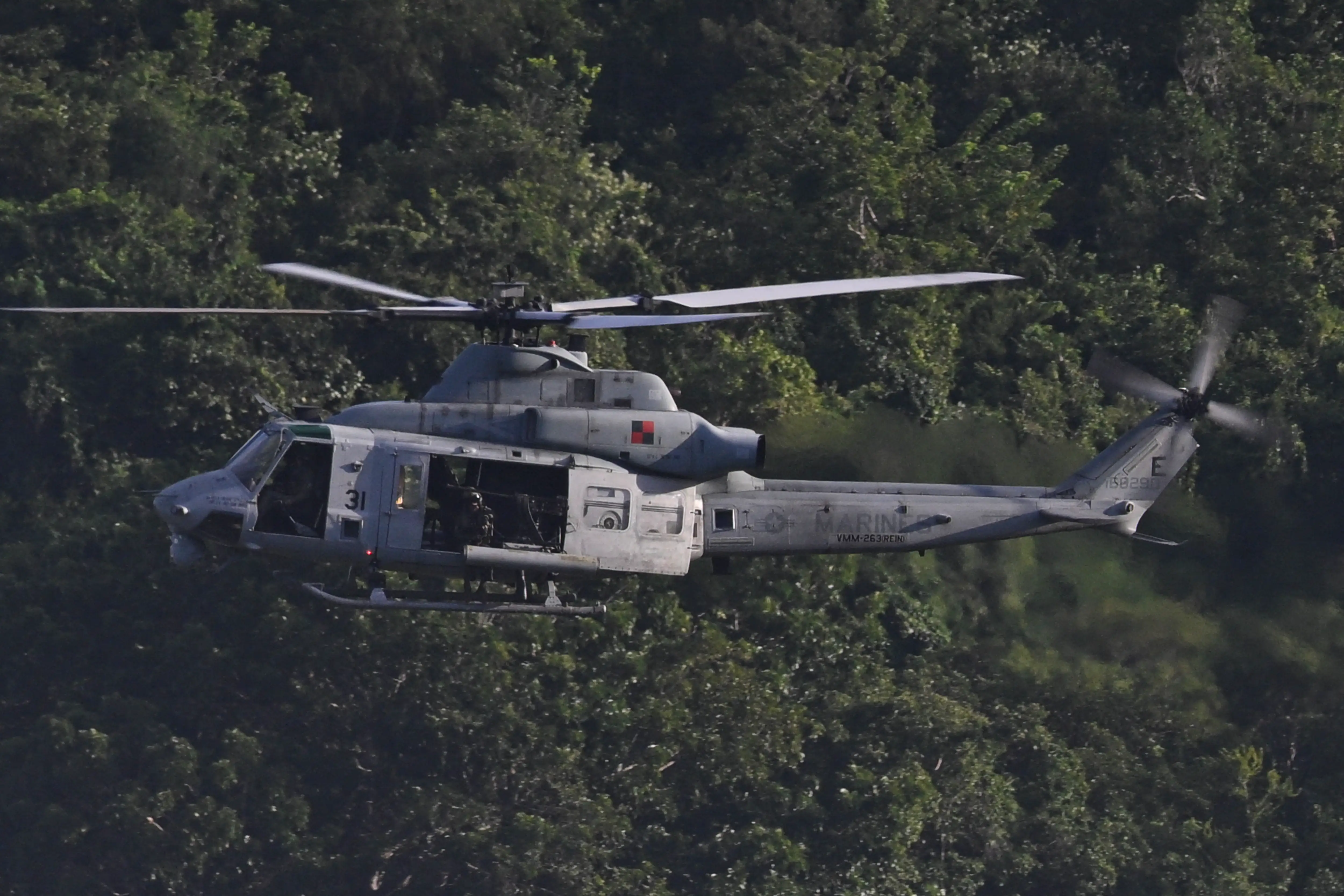 A US Marine Corps UH-1Y Venom helicopter flies above José Aponte de la Torre Airport, formerly Roosevelt Roads Naval Station, on December 15, 2025 in Ceiba, Puerto Rico.