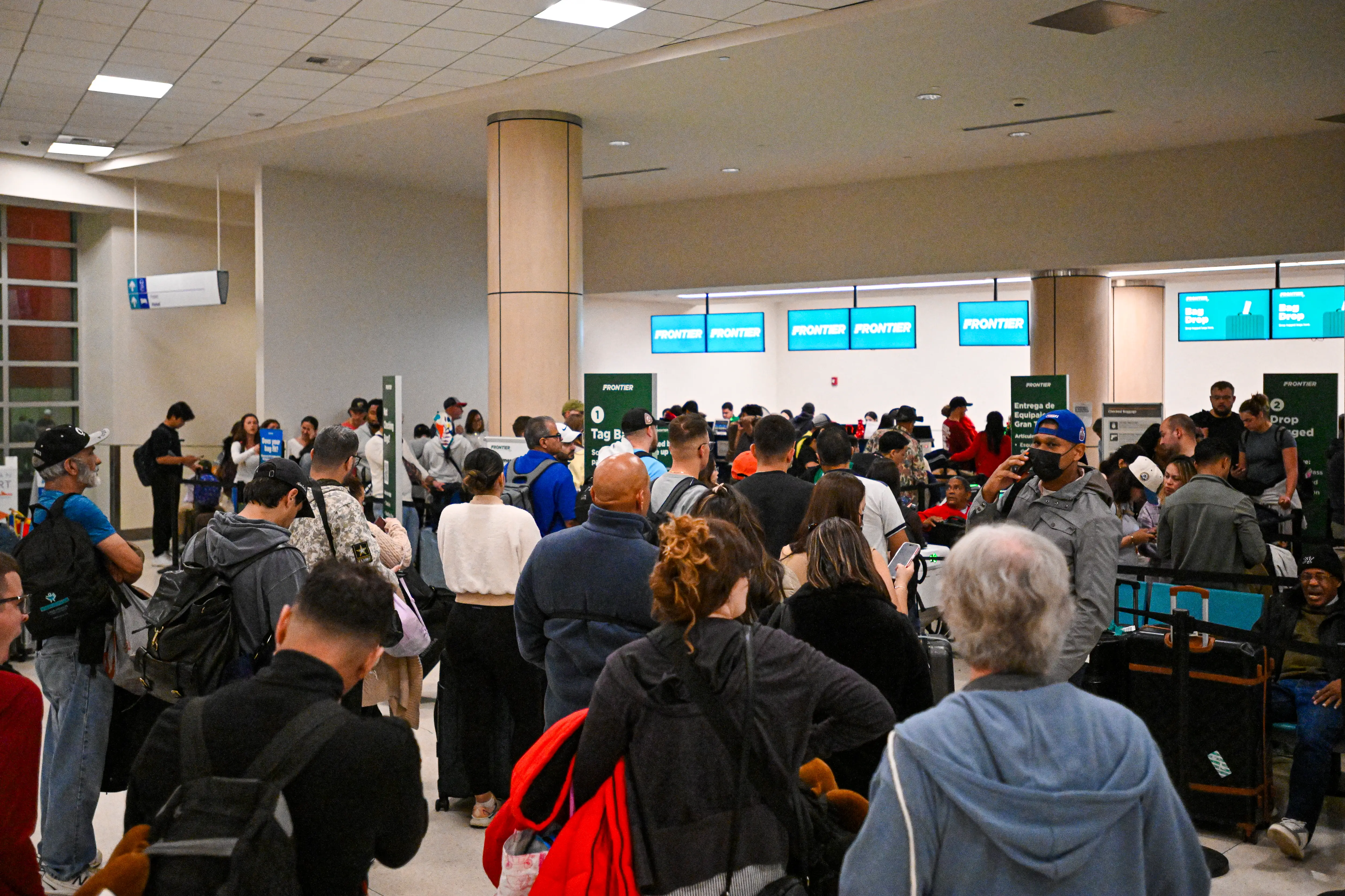 Passengers wait at Luis Munoz Marin International Airport as all flights are cancelled following US military action in Venezuela,