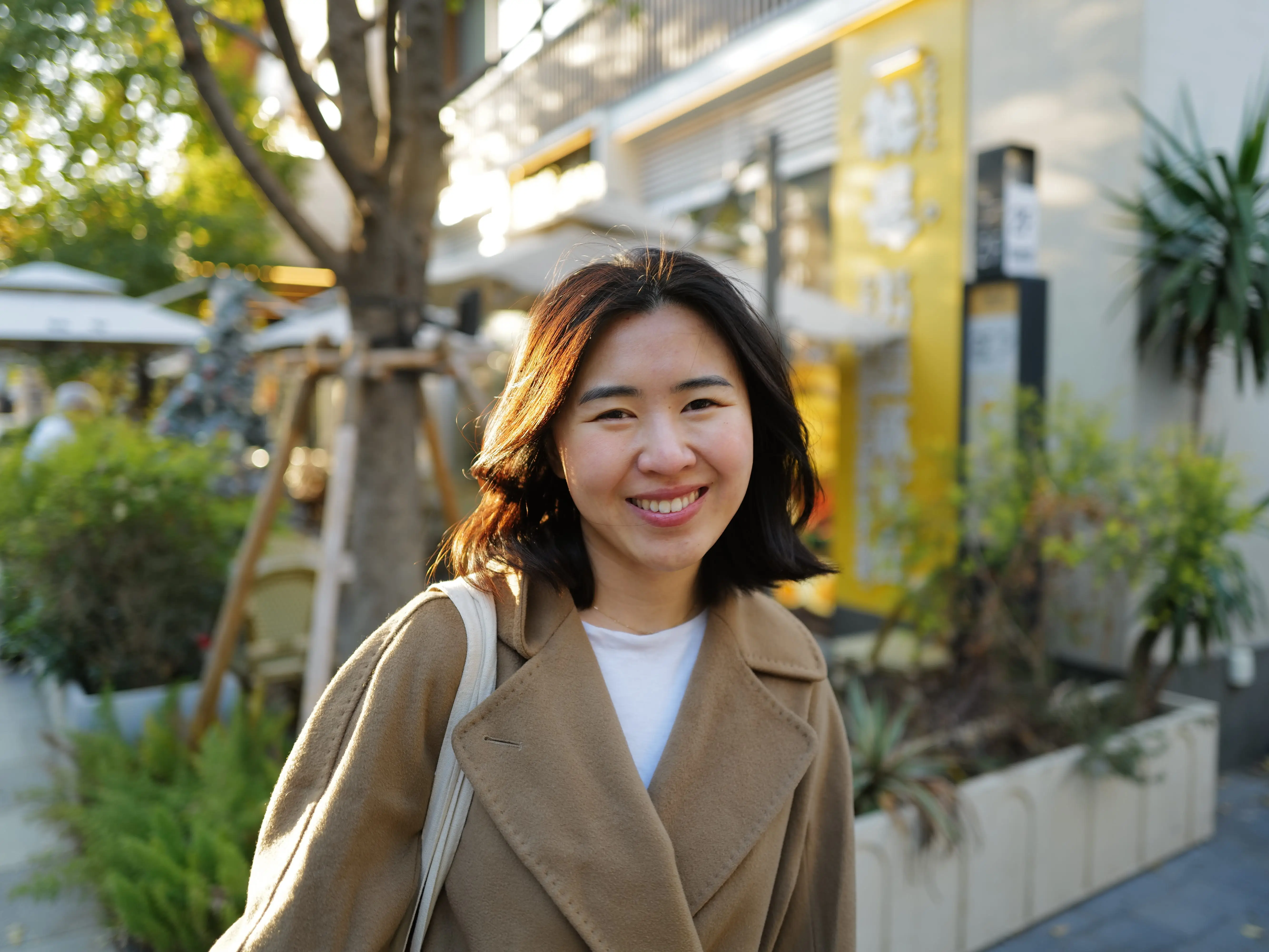 Portrait of a woman smiling t the camera.